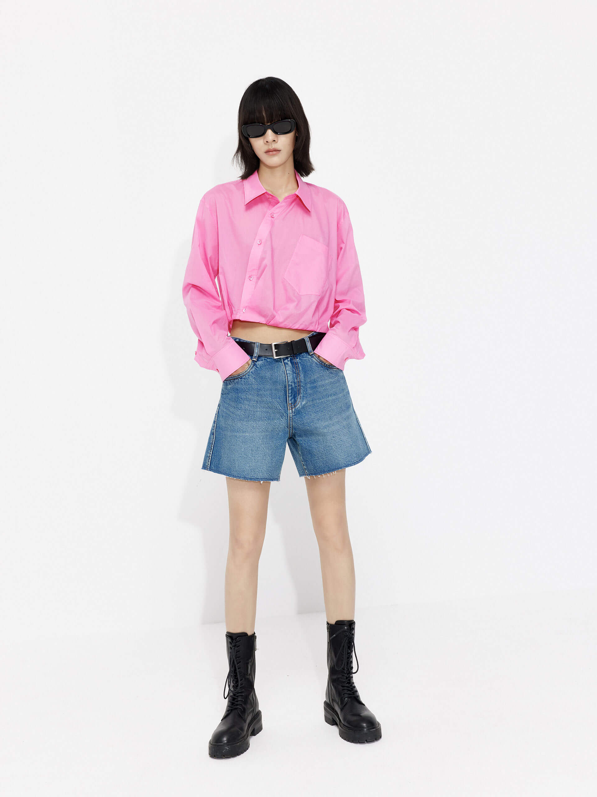 MO&Co. Women's Slanted Placket Cropped Shirt in Pink. Crafted with a stylish cropped silhouette and slanted placket design, this fashion-forward piece is bound to turn heads. Plus, it's complete with a front pocket and elastic hem for a unique look.