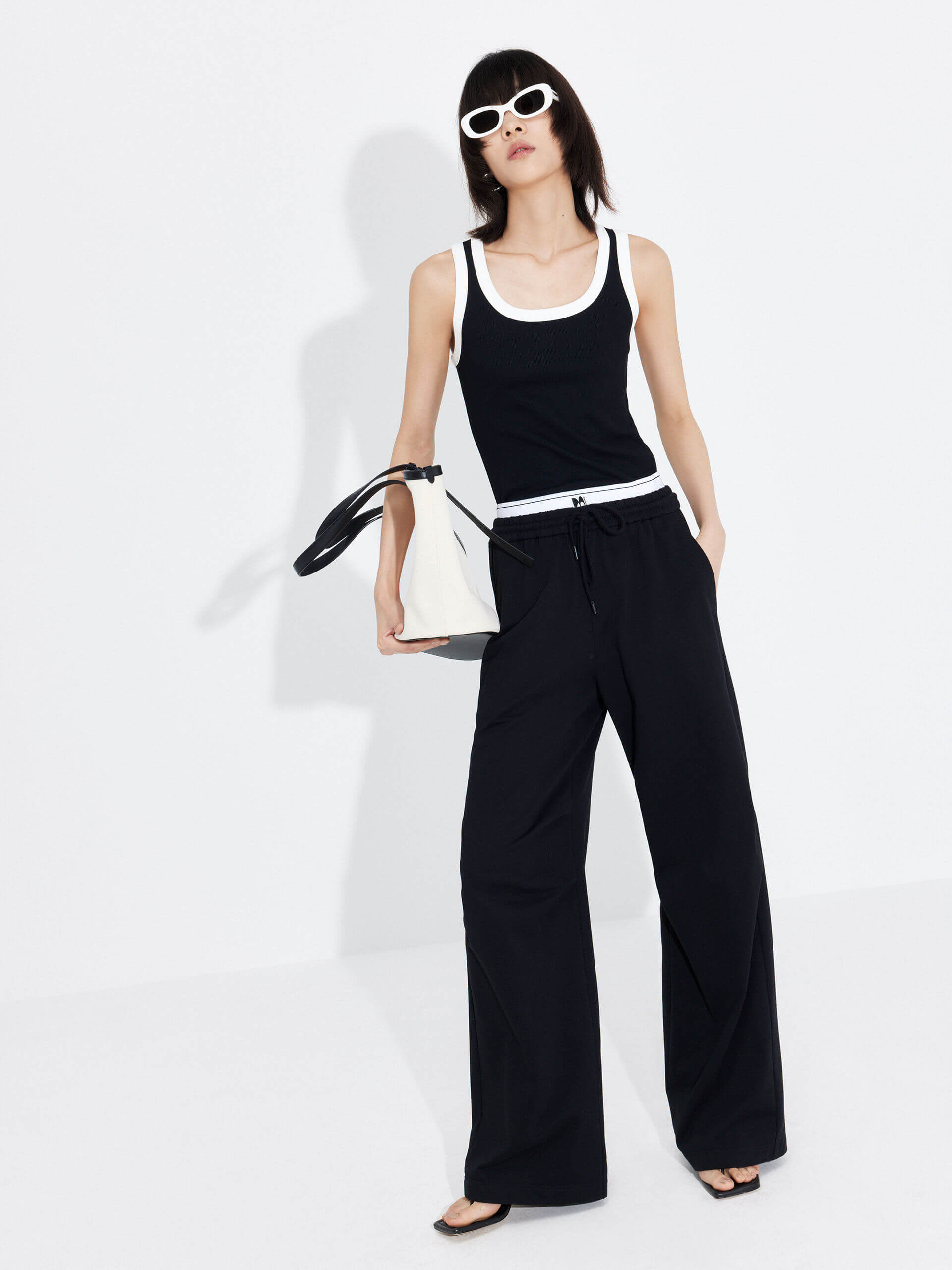 MO&Co. Women's Double Waistband Wide-leg Casual Trousers in Cotton - Black. Made from breathable cotton fabric, these sweatpants offer a relaxed, stylish fit complete with wide legs & slant pockets. Contrast double waistbands & letter details give them added style.