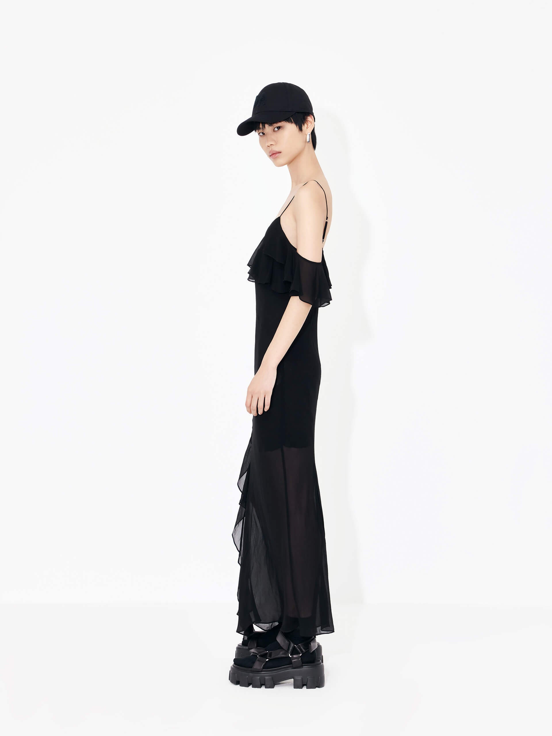 MO&Co. Women's Maxi Chiffon Slip Dress in Black features frill details, adjustable straps, cold shoulders, back slit detail, and recycled fiber material.