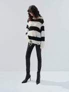 MO&Co. Noir Women's Distressed Detail Striped Oversized Pullover Crafted from a blend of mohair and wool, this sweater offers a fuzzy texture and distressed design for a modern twist. 