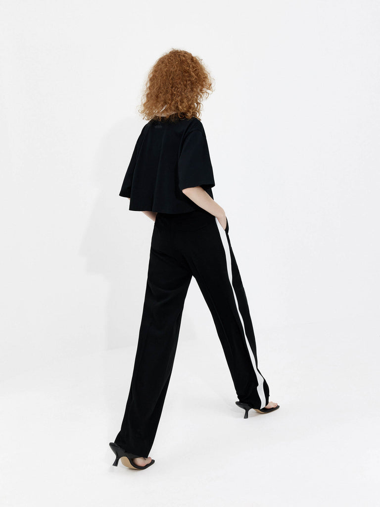 MO&Co. Women's Contrast Trim Straight Pants in Black: a fashionable look with white contrast trim design, wide and straight leg and side pockets, and belt loops and a zipper and hook closure.