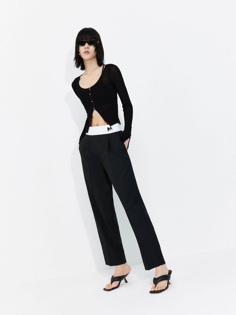 MO&Co. Women's Contrasting Details Suit Pants in Black. Crafted with a luxurious wool blend and featuring an eye-catching elastic waistband with an M pattern, these pants are designed for comfort and style. Double-side pockets and side zip closure complete the look.