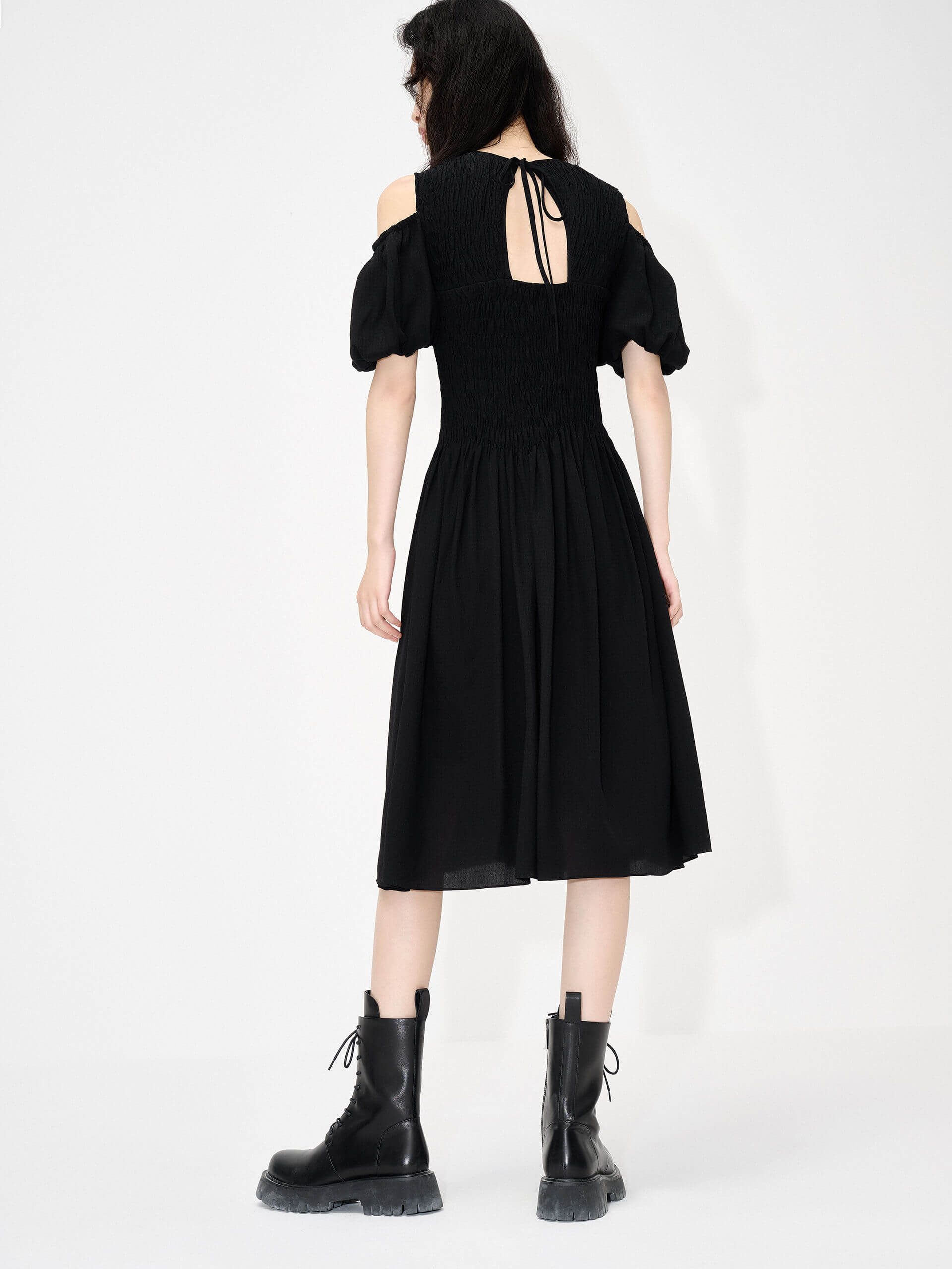 MO&Co. Women's Cut Shoulder Smocked Dress in Black. It features smocked detailing and shoulder cutouts for a flattering look with a unique, modern feel. Plus crafted from a blend of silk and polyester for an ultra-comfortable fit.