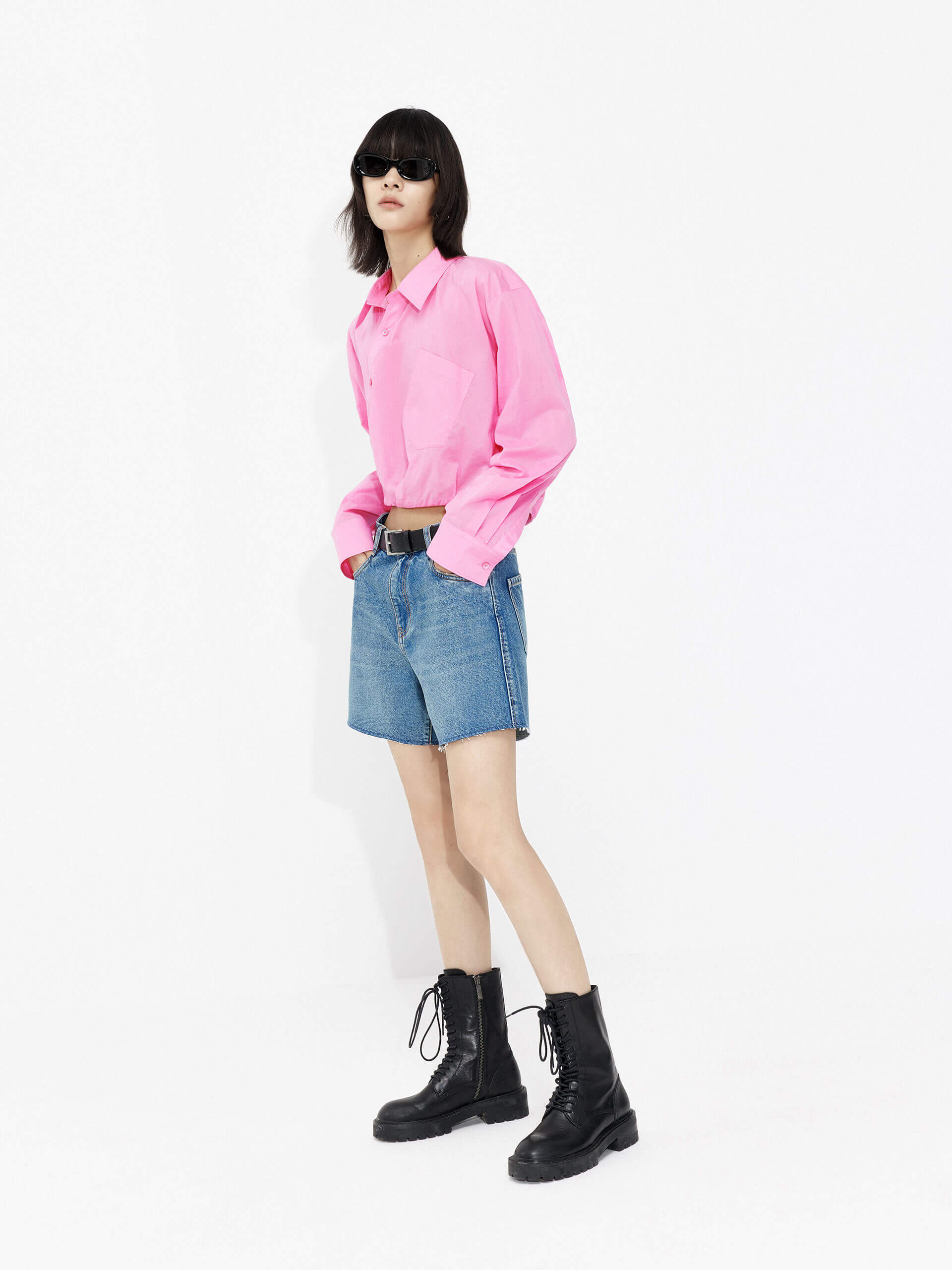 MO&Co. Women's Slanted Placket Cropped Shirt in Pink. Crafted with a stylish cropped silhouette and slanted placket design, this fashion-forward piece is bound to turn heads. Plus, it's complete with a front pocket and elastic hem for a unique look.