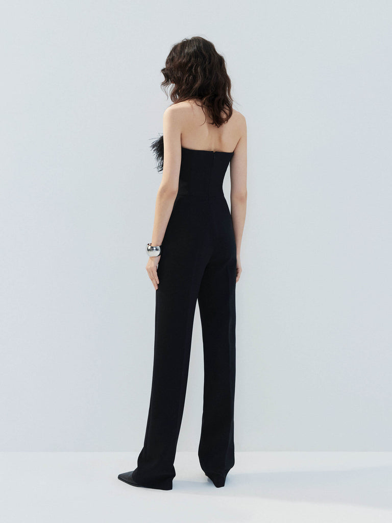 MO&Co. Noir Women's Feather Detail Fitted Jumpsuit Black features feather embellishments and a sleek straight-leg, strapless silhouette with a flattering fitted waist, ideal for a night out.