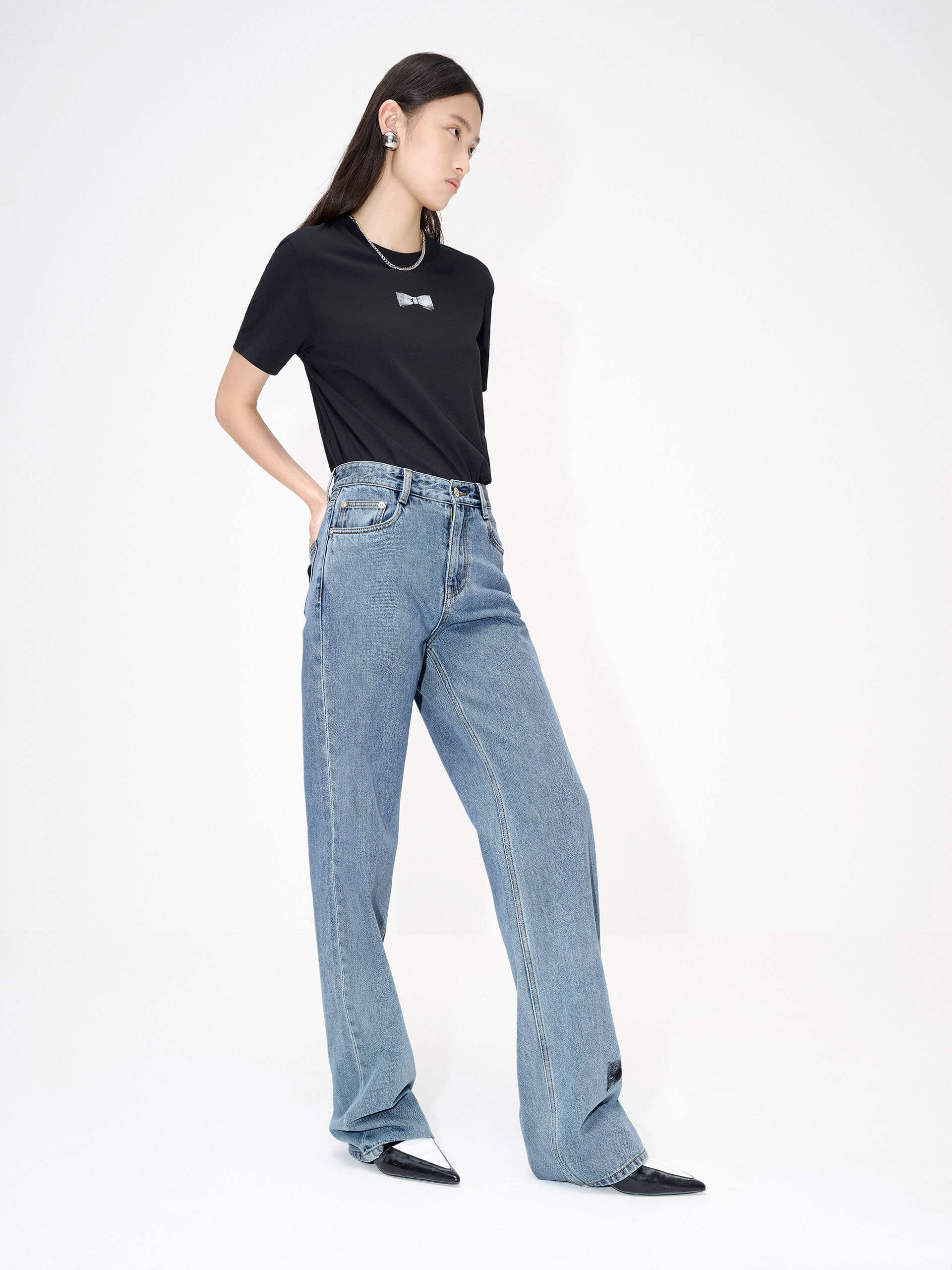 MO&Co. Women's Straight Bowknot Details Jeans in Blue. Featuring a high-waist design for a modern silhouette, these chic jeans are enhanced with bowknot-printed details at the back pocket and hem, adding a touch of femininity.