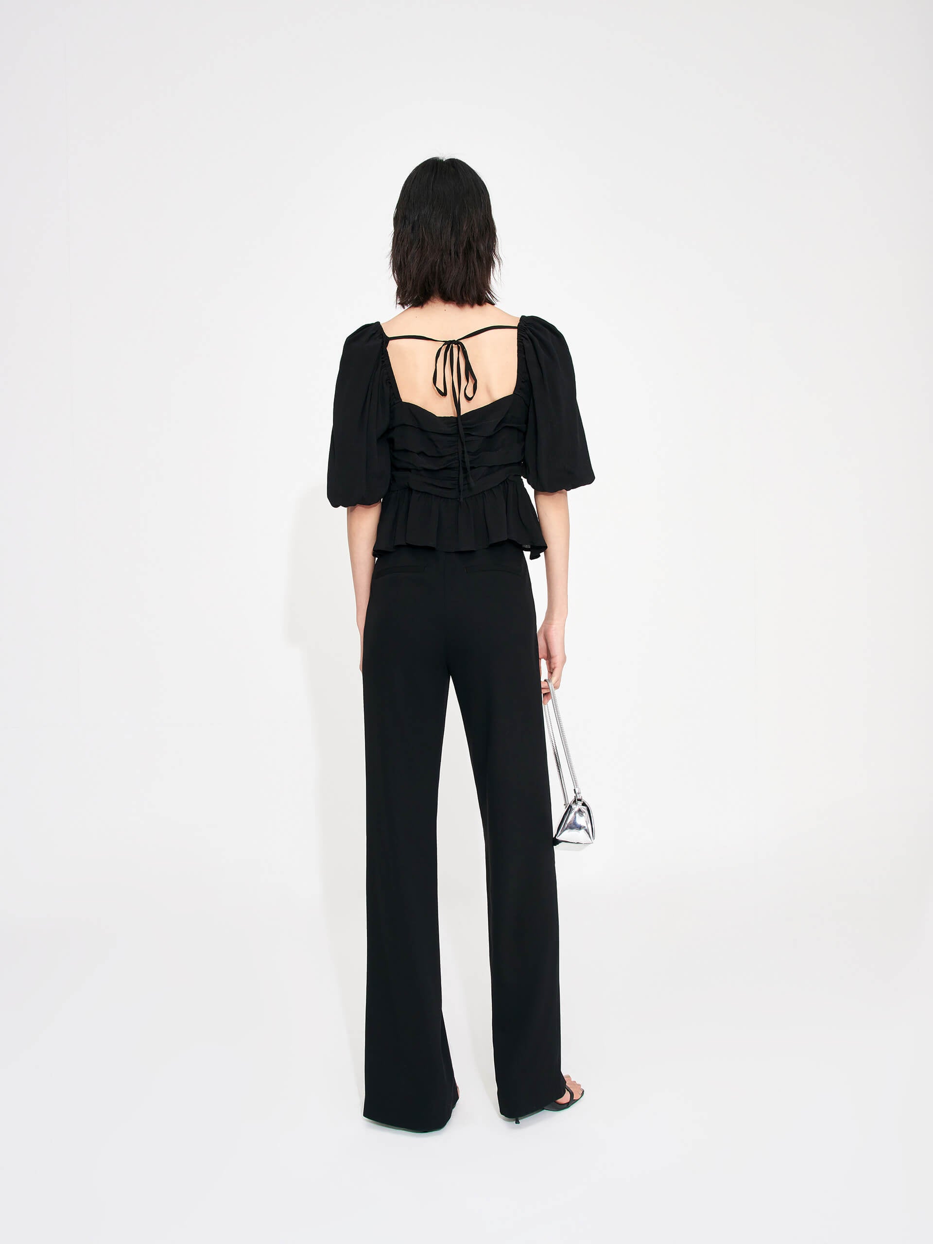 Bring a touch of luxury to your wardrobe with this MO&Co. Women's Pleated Detail Silk Top. Crafted from soft and lightweight silk material, it features a heart-shape neckline and puff sleeves with pleated details and a ruffled hem. The back of the top boasts an eye-catching tie-strap detail,