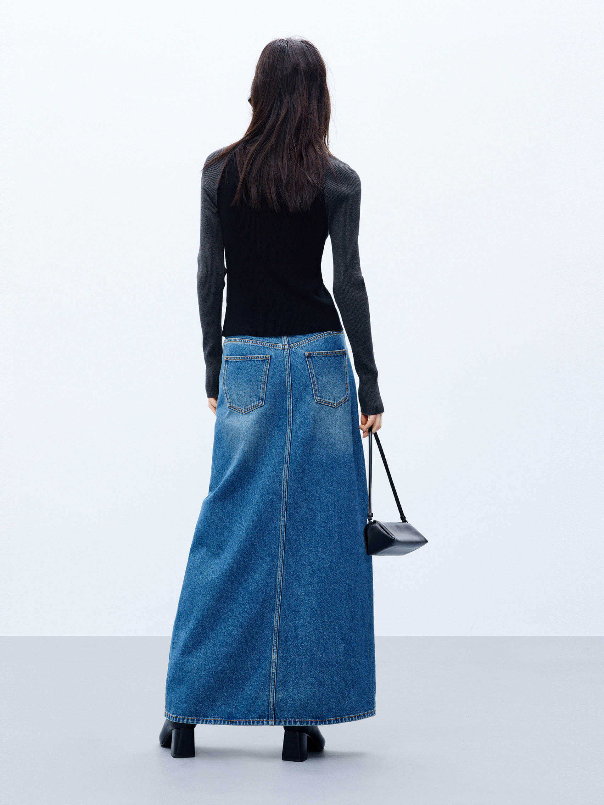 MO&Co. Women's Blue Front Split Maxi Denim Skirt boasting an asymmetrical waistband & an eye-catching front slit. With five classic pockets & button & zip closure, this maxi length skirt is a must-have for any event.