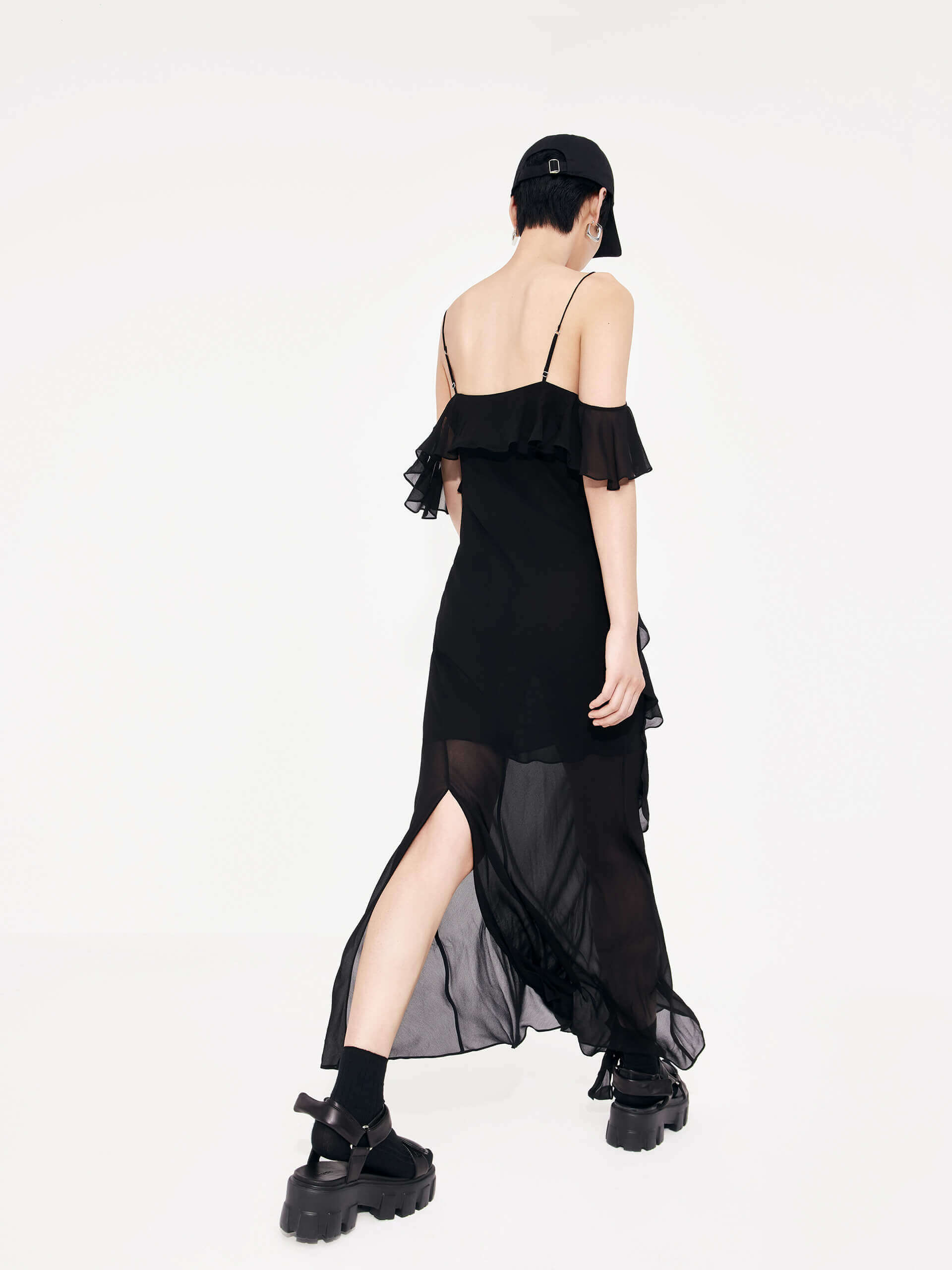 MO&Co. Women's Maxi Chiffon Slip Dress in Black features frill details, adjustable straps, cold shoulders, back slit detail, and recycled fiber material.