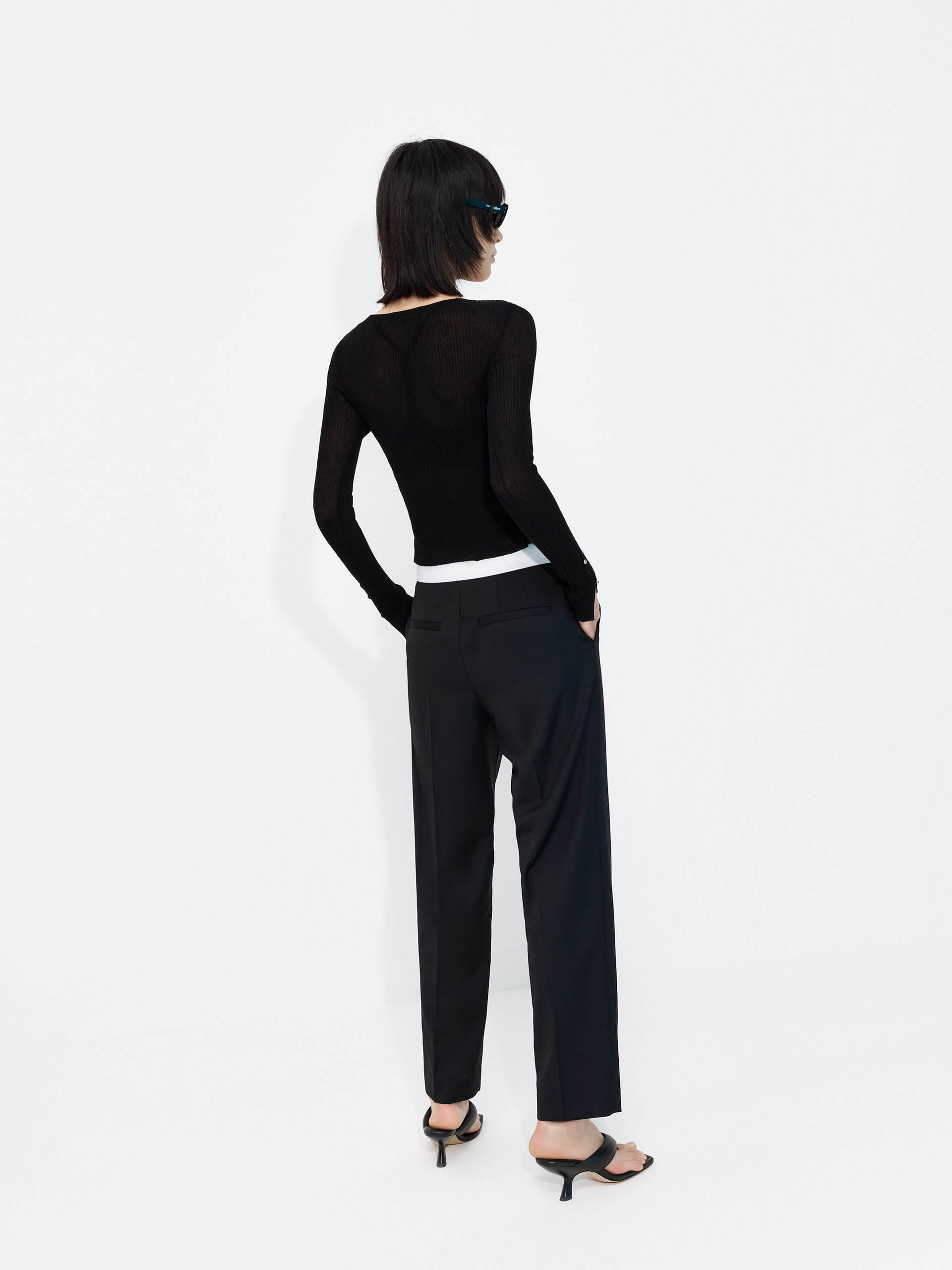 MO&Co. Women's Contrasting Details Suit Pants in Black. Crafted with a luxurious wool blend and featuring an eye-catching elastic waistband with an M pattern, these pants are designed for comfort and style. Double-side pockets and side zip closure complete the look.