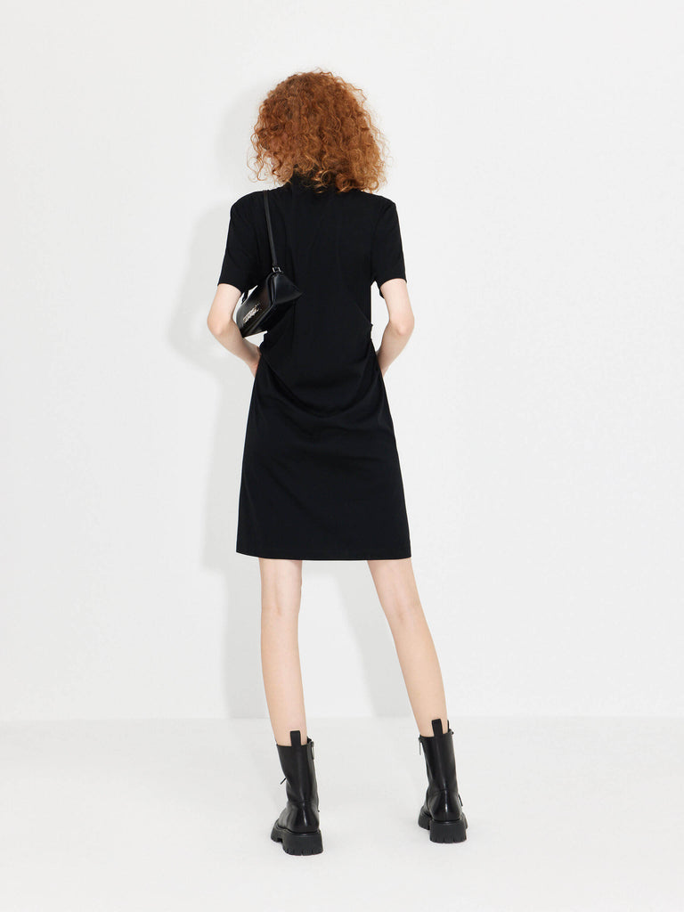 MO&Co. Women's Stand Collar Pleated Mini Dress in Black showcases an accentuated waistline, classic mandarin collar, and a unique slanted placket with metal button details for a perfect blend of classic and modern.