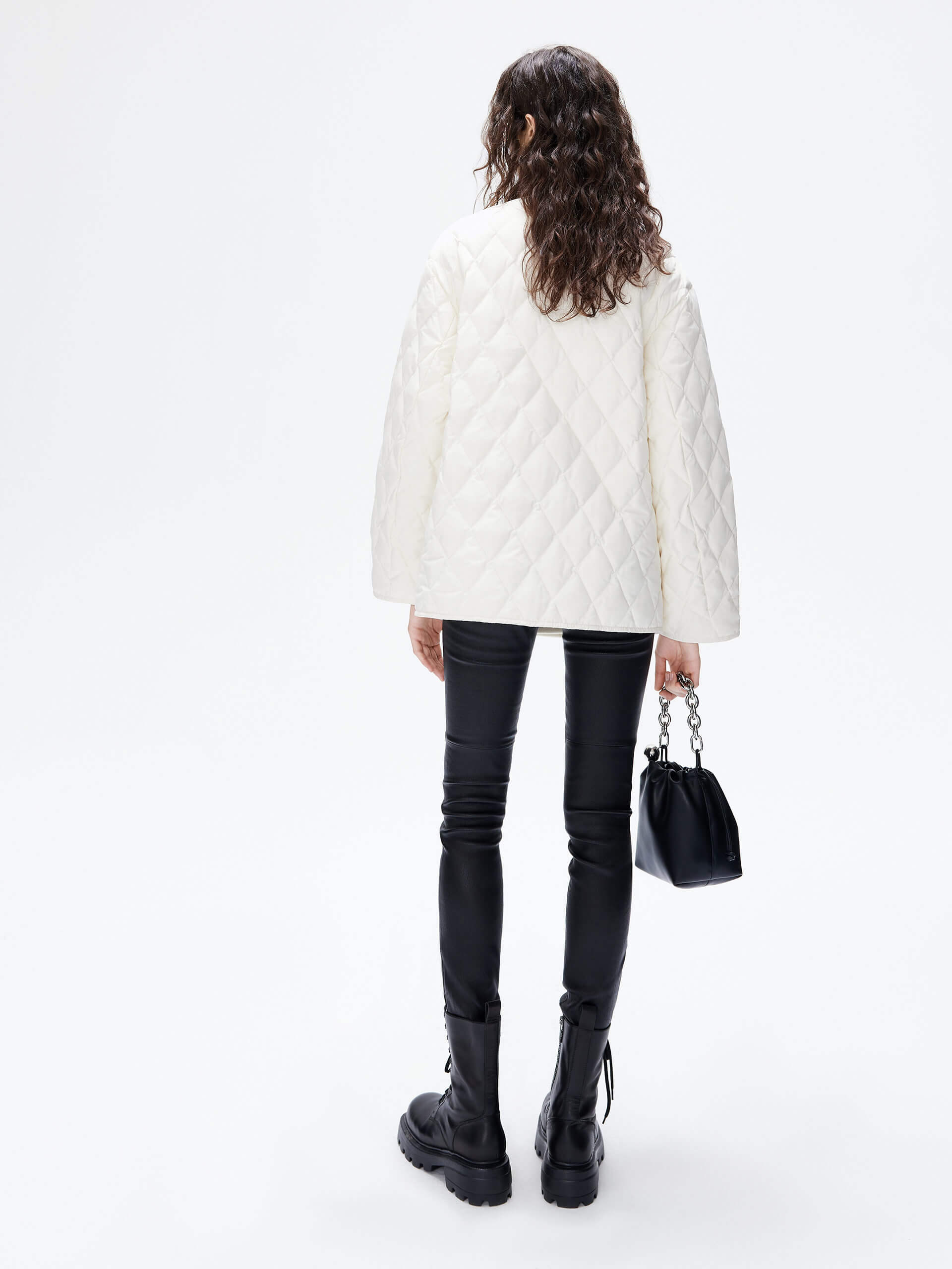 MO&Co. Women's V-neck Quilted Shell Wool Blend Jacket in White, featuring a button closure and flap pocket design. Wool panel front , quilted shell sleeves and back add a unique touch and extra warmth. 