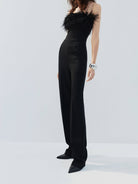 MO&Co. Noir Women's Feather Detail Fitted Jumpsuit Black features feather embellishments and a sleek straight-leg, strapless silhouette with a flattering fitted waist, ideal for a night out.