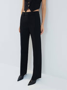 MO&Co. Noir Women's Tailored Straight Black Wool Suit Pants. The straight legs, full length design, hook-and-bar closure, and slanted pockets add to the tailored appeal of these versatile pants.