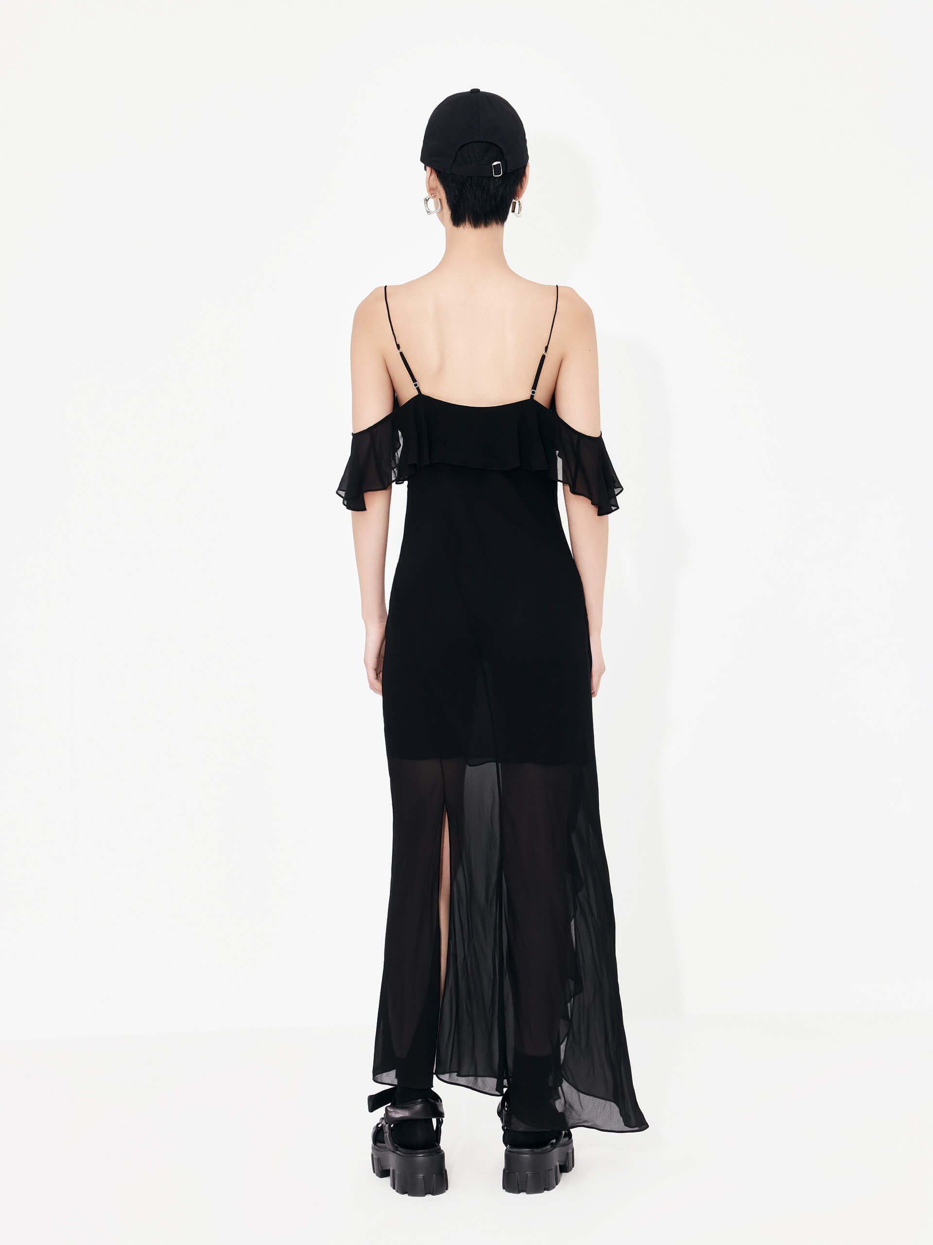 MO&Co. Women's Maxi Chiffon Slip Dress in Black features frill details, adjustable straps, cold shoulders, back slit detail, and recycled fiber material.