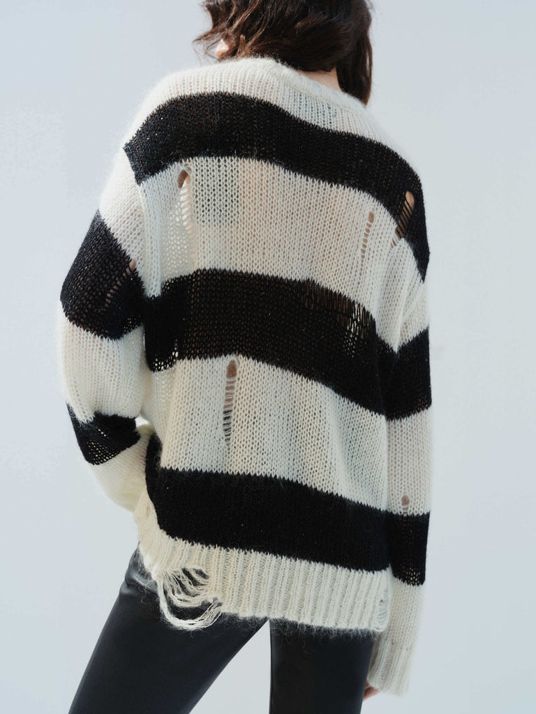 MO&Co. Noir Women's Distressed Detail Striped Oversized Pullover Crafted from a blend of mohair and wool, this sweater offers a fuzzy texture and distressed design for a modern twist. 