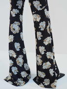 MO&Co. Noir Women's Floral Printed Full Length Flared Pants with a high waist, flared leg, comfy stretchy material, slanted pockets, and hook-and-bar closure, these pants offer both style and functionality.