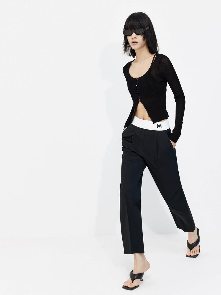 MO&Co. Women's Contrasting Details Suit Pants in Black. Crafted with a luxurious wool blend and featuring an eye-catching elastic waistband with an M pattern, these pants are designed for comfort and style. Double-side pockets and side zip closure complete the look.