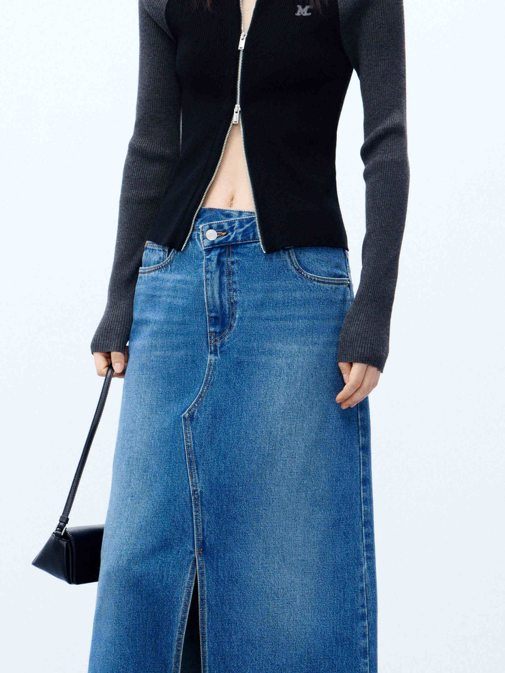 MO&Co. Women's Blue Front Split Maxi Denim Skirt boasting an asymmetrical waistband & an eye-catching front slit. With five classic pockets & button & zip closure, this maxi length skirt is a must-have for any event.