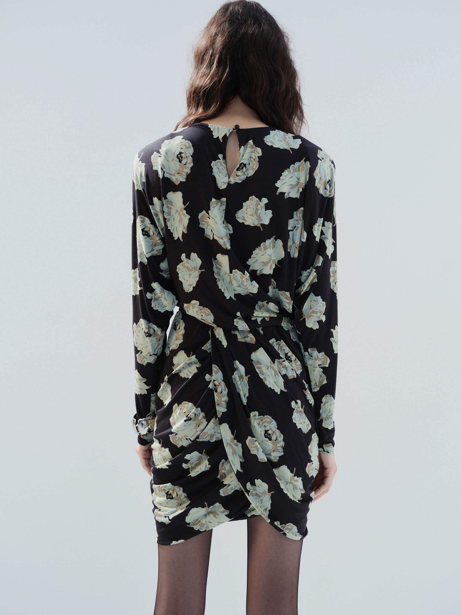 MO&Co. Noir Women's Floral Printed Long Sleeves Retro Mini Dress with padded shoulders, and a draped, ruched front.