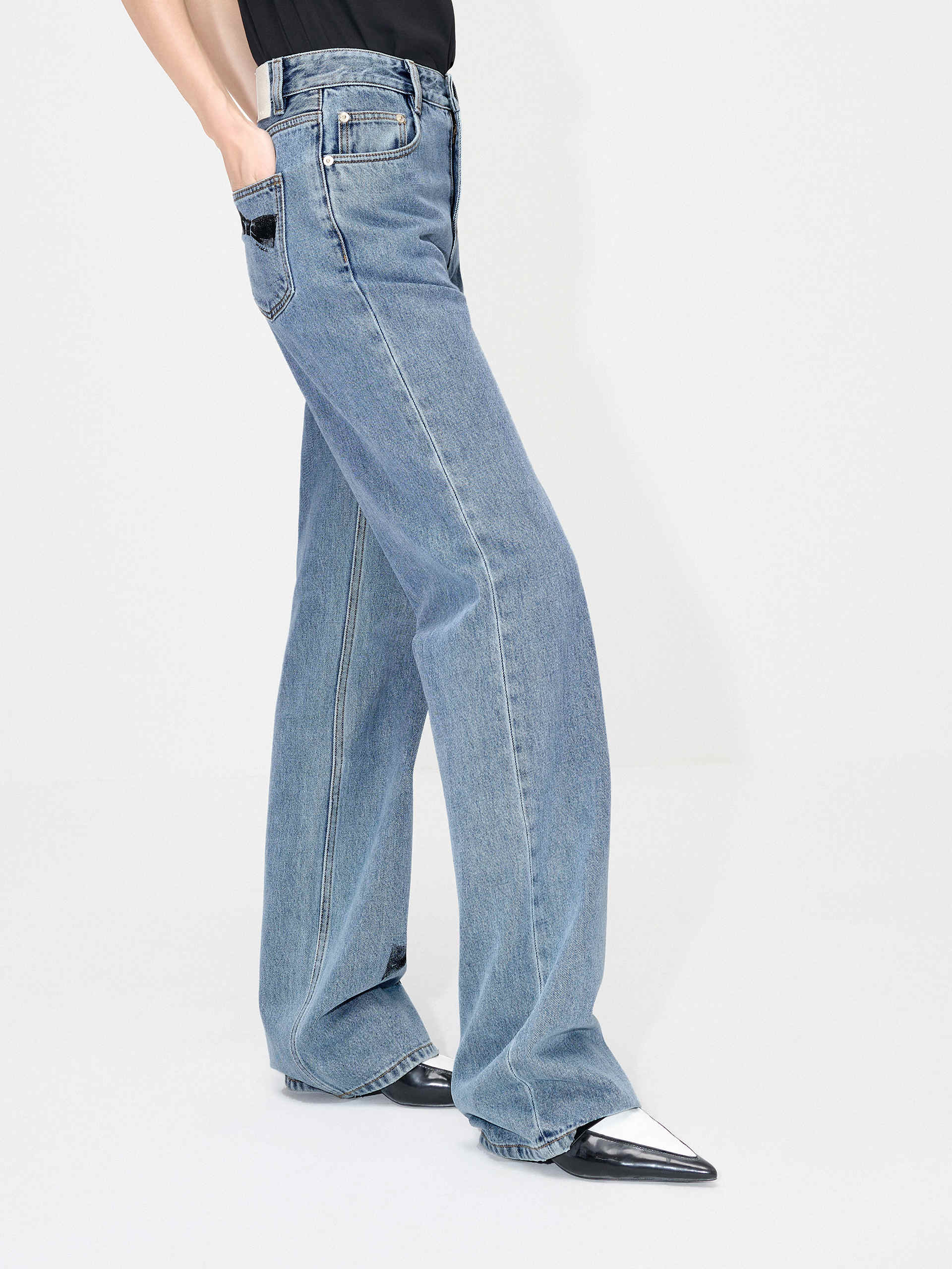 MO&Co. Women's Straight Bowknot Details Jeans in Blue. Featuring a high-waist design for a modern silhouette, these chic jeans are enhanced with bowknot-printed details at the back pocket and hem, adding a touch of femininity.