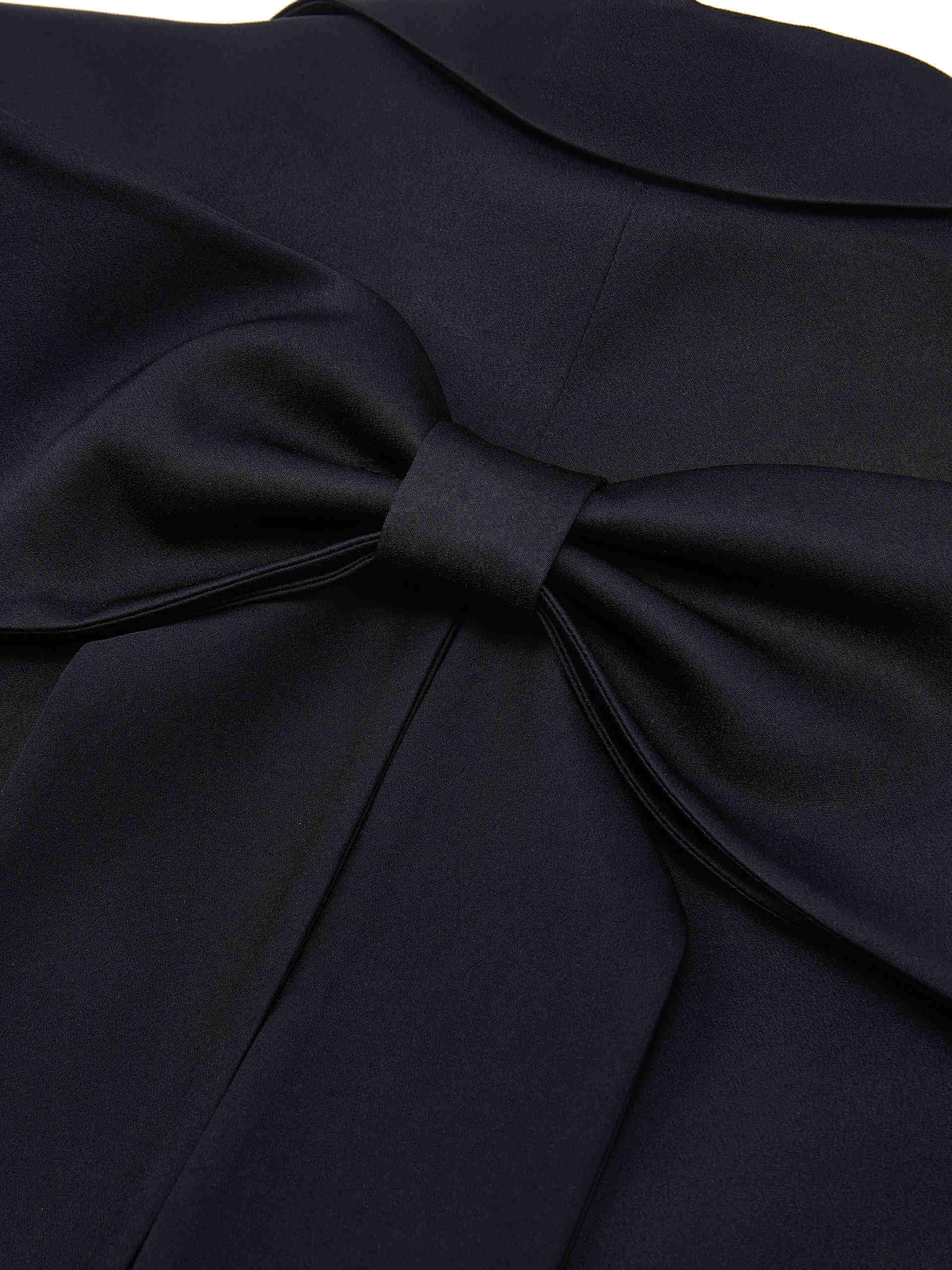 MO&Co. Bowknot Details Structured Blazer in Black. Made from comfy, smooth acetate blend materials with intricate bowknot and slit details on the back, this blazer also includes shoulder pads and a button closure.