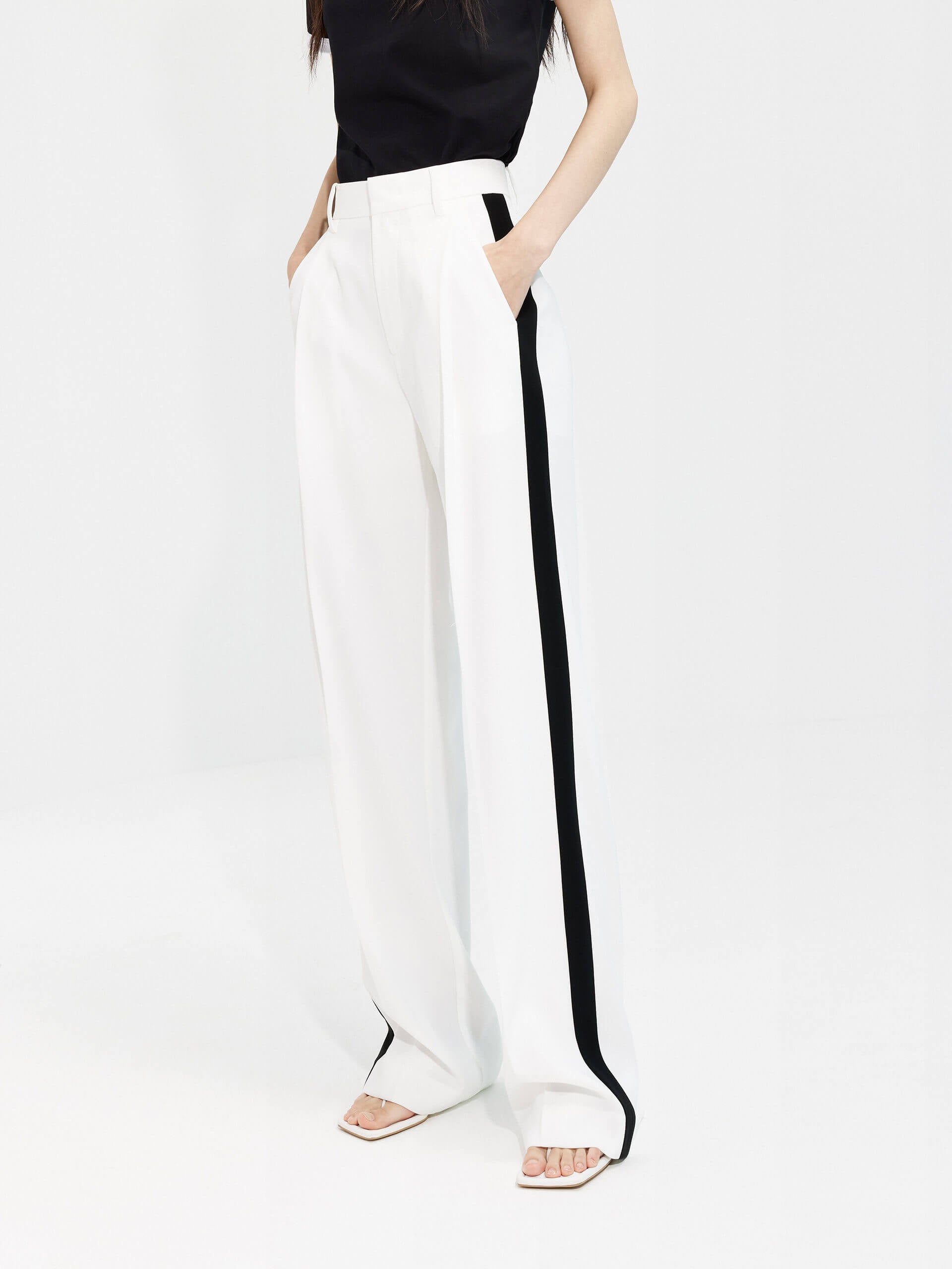 MO&Co. Women's Contrast Trim Suit Pants in White offer timeless style and lasting comfort. Features include contrast trim design, straight leg, side pockets, belt loops, and a zipper and hook closure.