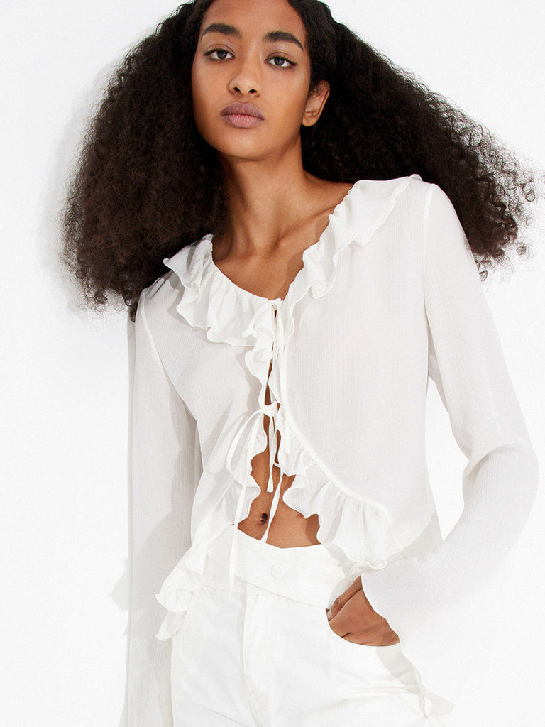 MO&Co.'s Silk Ruffled Trim Top Blouse in White your go-to for a touch of elegance with its comfortable fit, flared sleeves, and self-tie knot closure with ruffle trim design, this high-quality blouse is sure to impress.