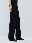 MO&Co. Noir Women's Feather Detail Fitted Jumpsuit Black features feather embellishments and a sleek straight-leg, strapless silhouette with a flattering fitted waist, ideal for a night out.