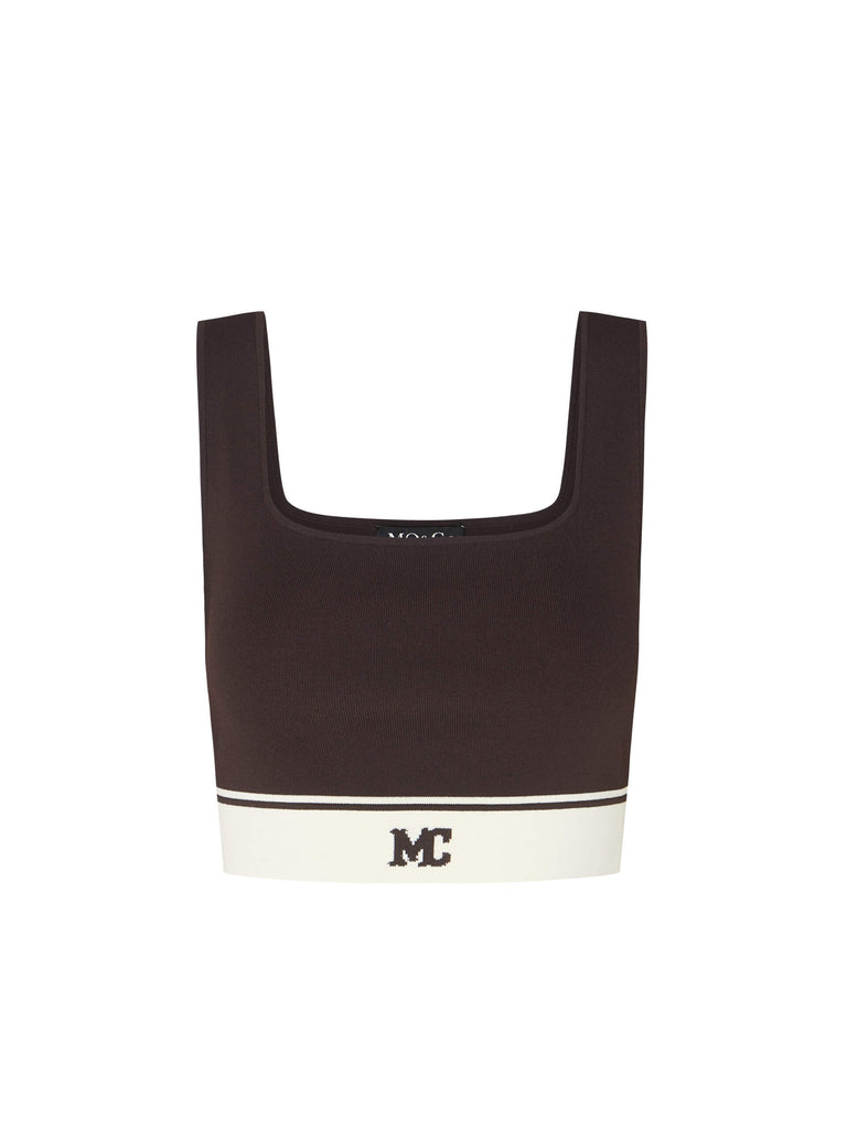 MO&Co. Women's Cropped Tank Top with Stretchy in Brown. Featuring a 50.9% viscose blend with a hint of stretch, squared neckline, a chic cropped silhouette & contrast palette with an "MC" logo.