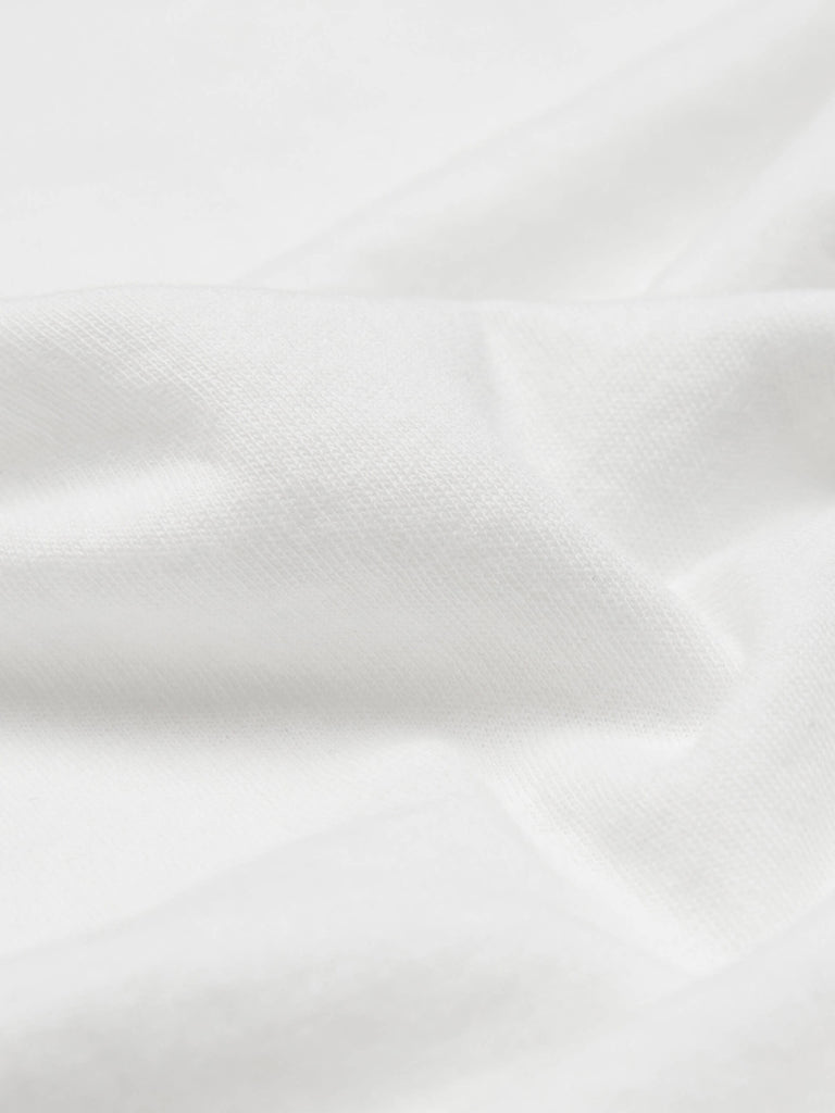 MO&Co. Noir Women's Cotton Drop Shoulder White T-shirt. Crafted from a lightweight and slightly sheer cotton fabric, this t-shirt offers a relaxed and airy feel perfect for warm days.
