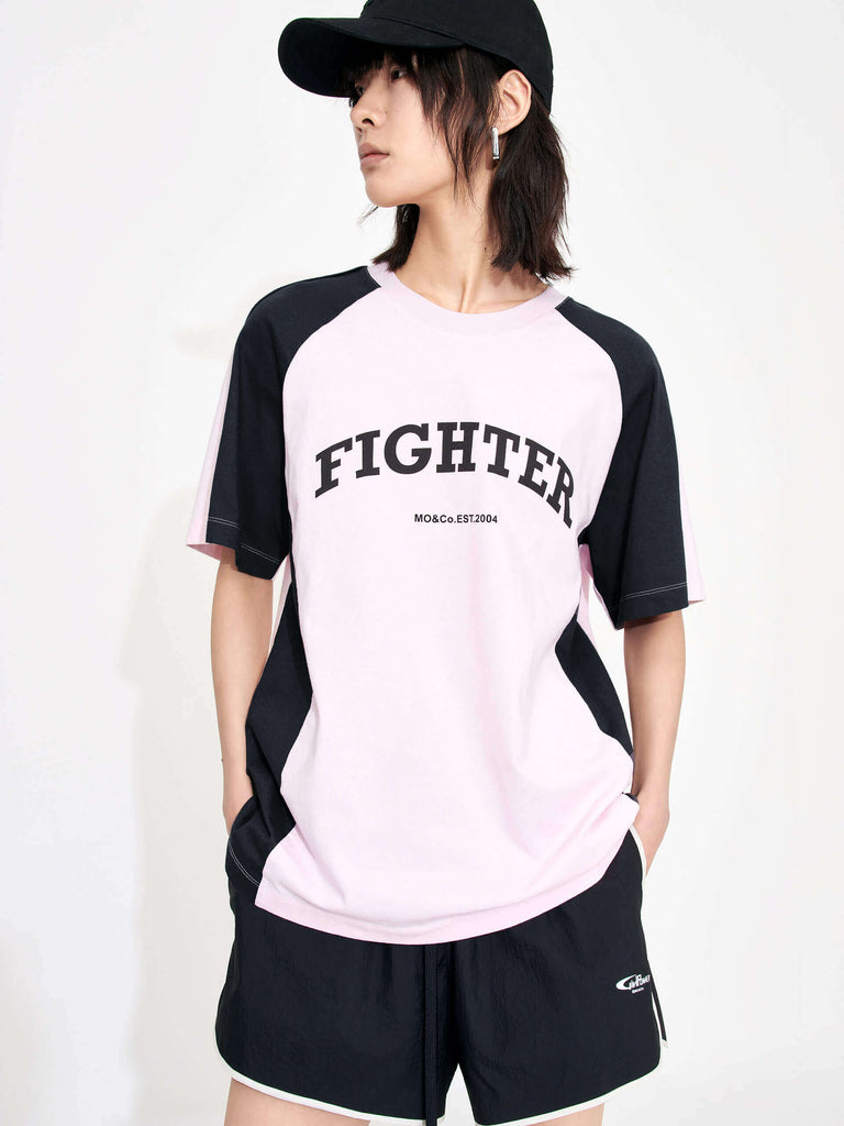 MO&Co. Women's Color Block Letter Print Relaxed Fit Cotton T-shirt in Pink featuring raglan sleeves with color block details, a letter print on the chest, the relaxed fit and crew neckline give you maximum comfort wherever you go.
