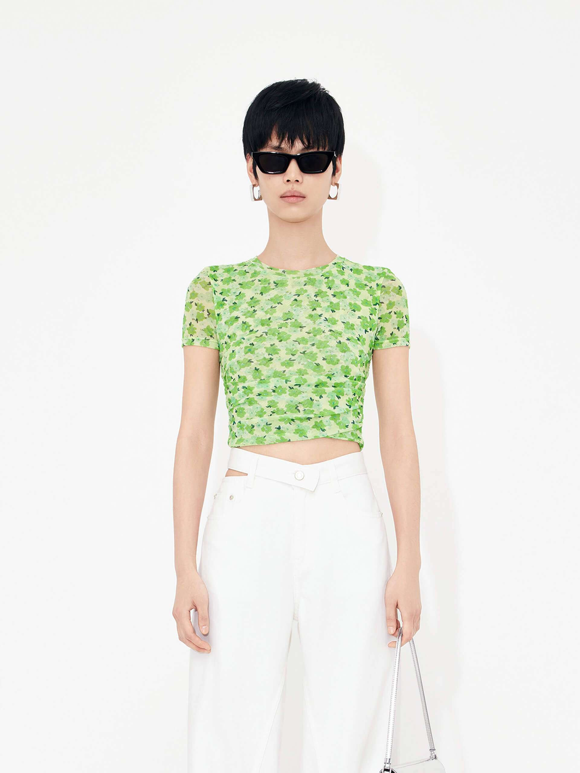 Stay stylish and comfortable with MO&Co.'s Floral Print Pleated Crop Top in Green. Crafted with lightweight mesh fabric and pleated side details, this top will flatter your shape while the fresh floral print adds an elegant touch.