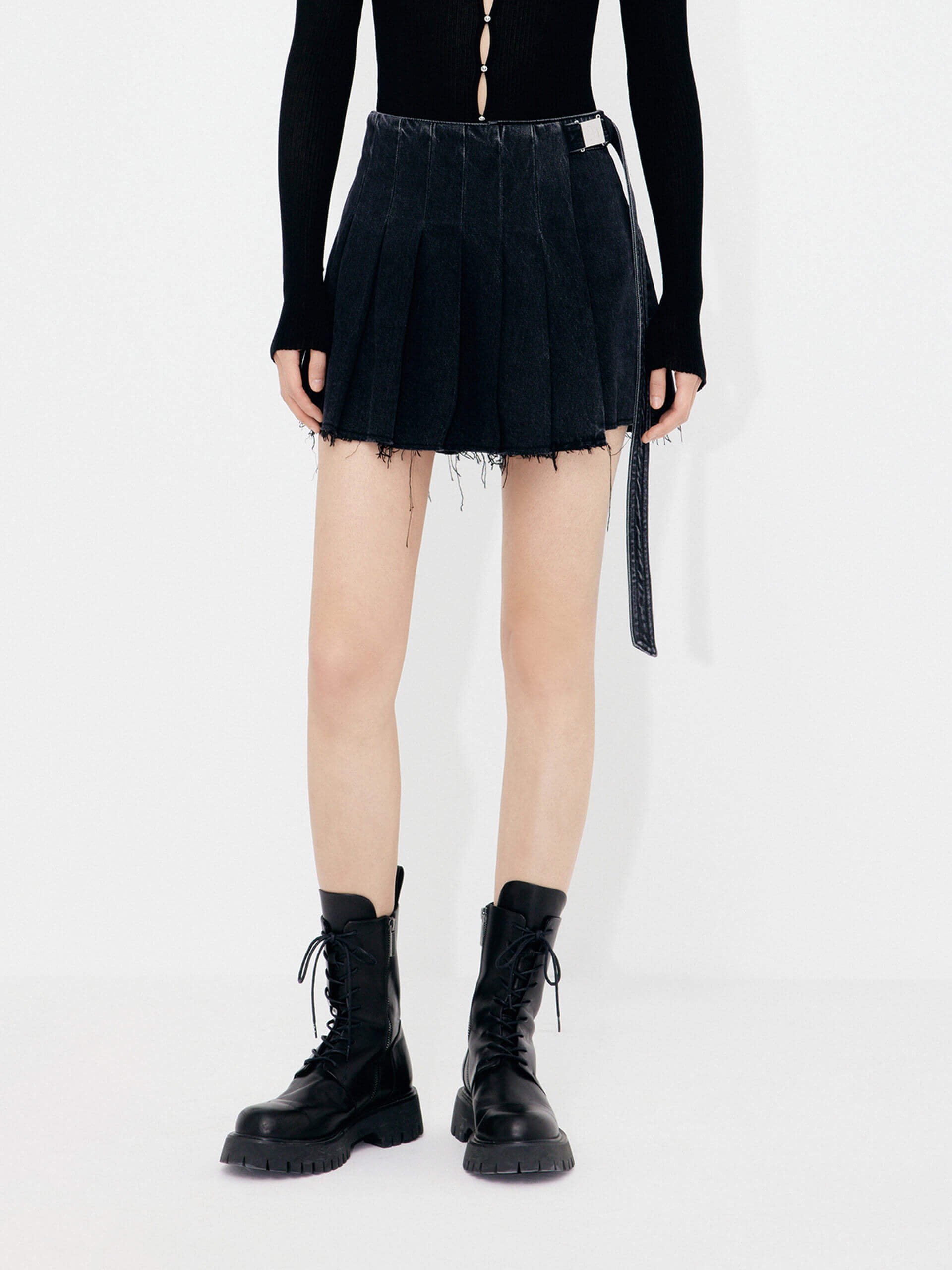 MO&Co.'s Women's Wrap Detail Pleated Black denim Shorts. Features include mini length, raw hem details and a wrap pleated patch with buckle belt.