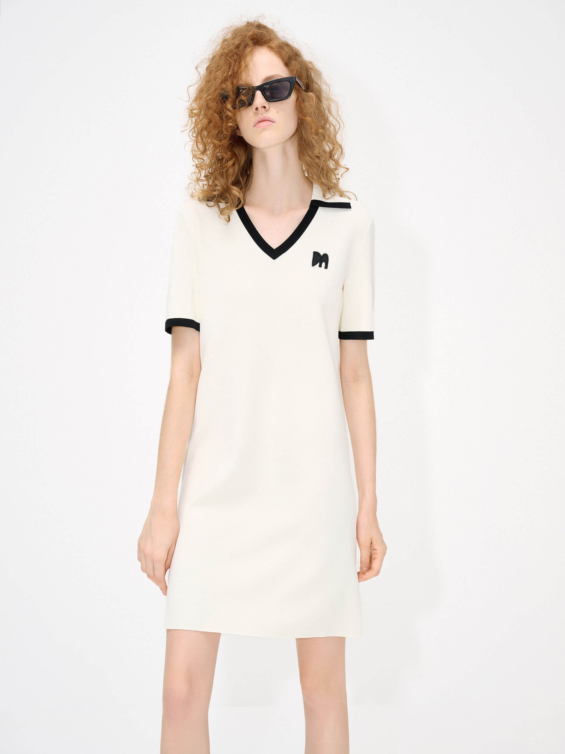 MO&Co. Women's Polo Collar Contrast Beige Dress features include a V-neck with collar design, contrasting trim details, and an embroidered M logo patch front. 