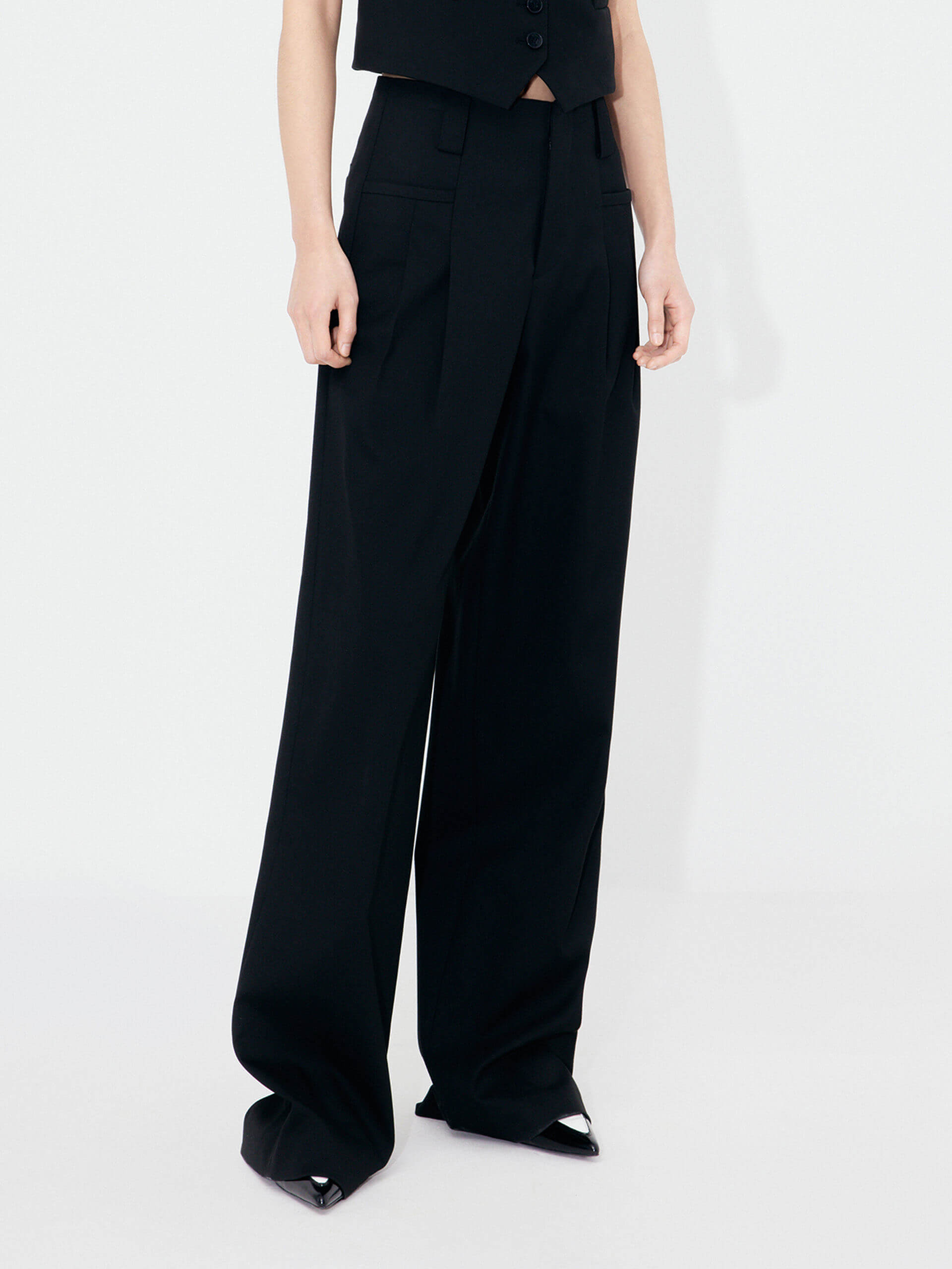 MO&Co. Women's Mid-rise Pleated Suit Pants in Black. Cut with a wide, straight leg and pleats on the front, these chic pants have a zipper and hook closure, plus belt loops for an extra polished look.