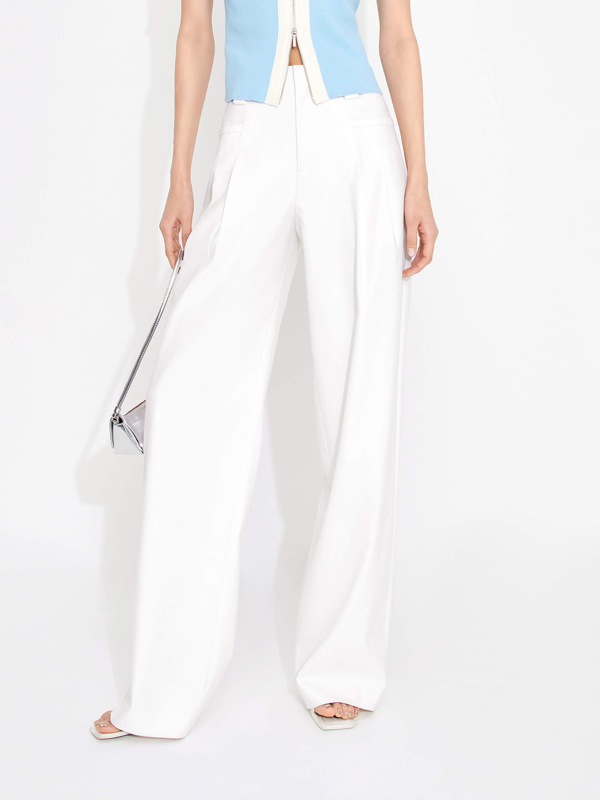 MO&Co. Women's Mid-rise Pleated Suit Pants in White. Cut with a wide, straight leg and pleats on the front, these chic pants have a zipper and hook closure, plus belt loops for an extra polished look.