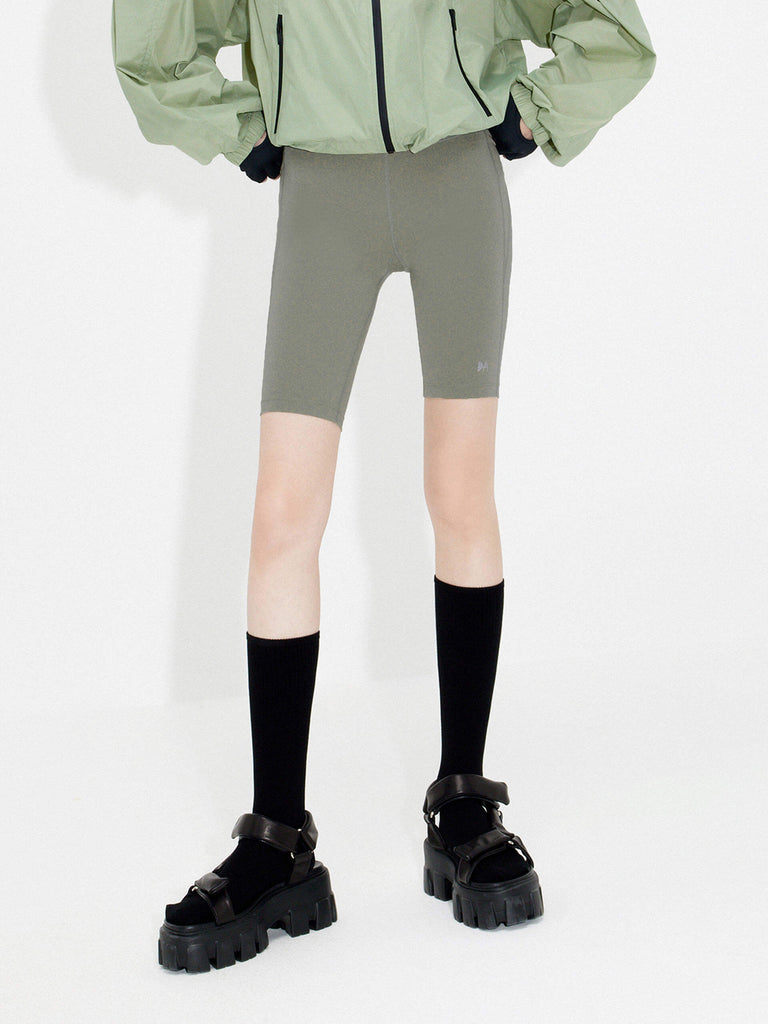 Try MO&Co.'s High Waist Sports Shorts in Olive for women! These biker shorts hug your shape, thanks to stretchy material that moves with you. Plus, they feature a high rise with an elasticized waistband.