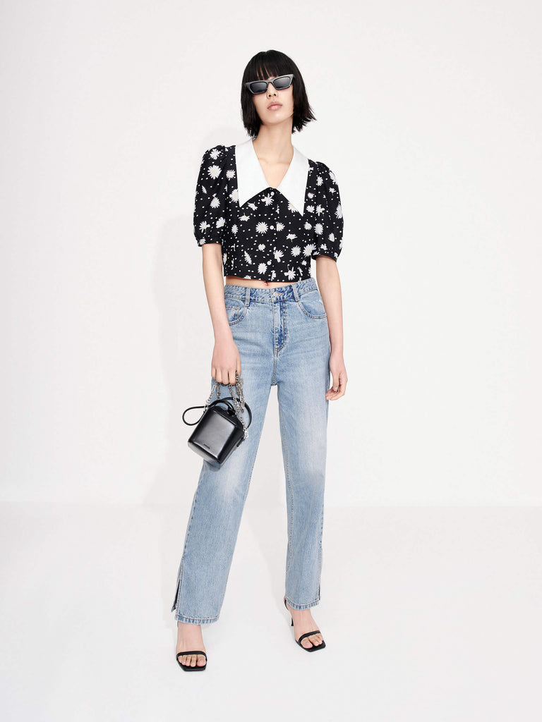 MO&Co.'s Floral Print Crop Top in Black offers a luxuriously stylish addition to any summer wardrobe. Made from a silk blend, this top features a Chelsea neckline, bubble sleeves and a beautiful floral and polka dot print design.