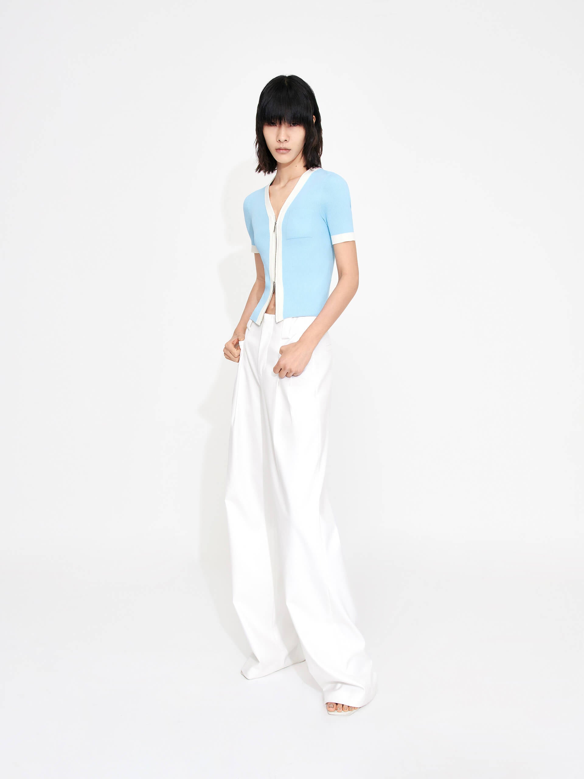 MO&Co. Women's Mid-rise Pleated Suit Pants in White. Cut with a wide, straight leg and pleats on the front, these chic pants have a zipper and hook closure, plus belt loops for an extra polished look.