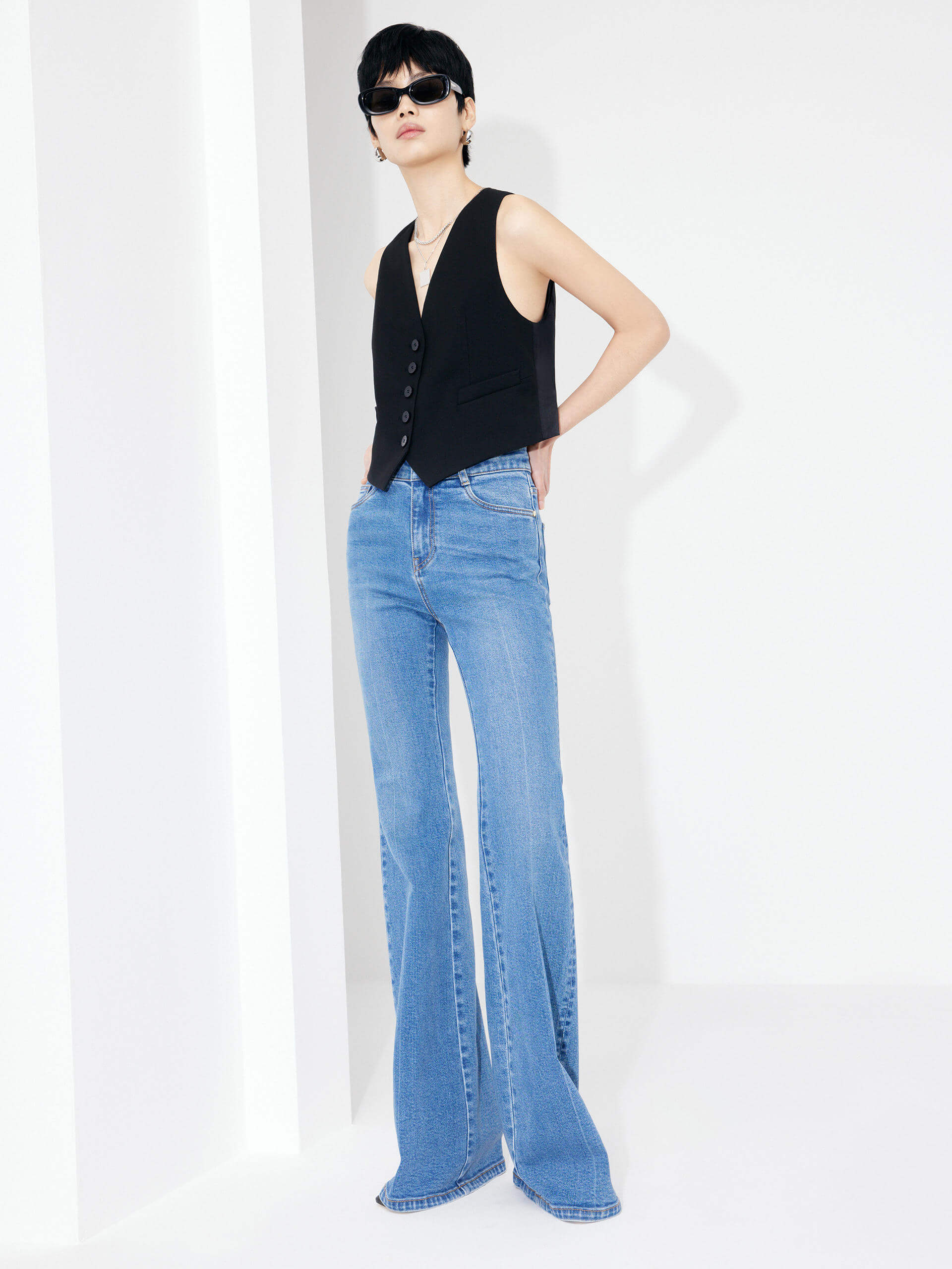 Experience MO&Co.'s Women's Full Length Flared Jeans - featuring flared legs, button and zip closure, five-pocket design, whiskered effect and belt loops alongside a leather logo patch at back waistband.