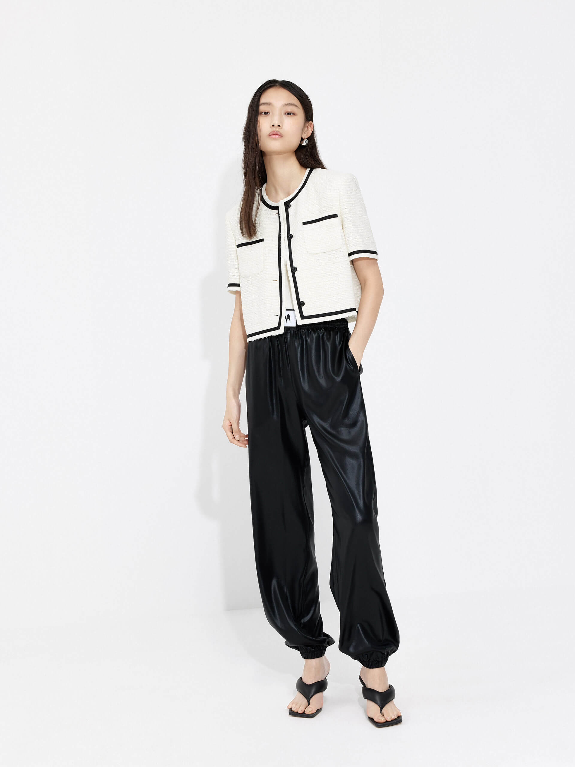 MO&Co. Women's Triacetate Blend Elastic Waist Jogger Pants in Black with Side Slant Pockets, an Elasticated Waist with Woven Label Front Details, and an Elasticized Hem!