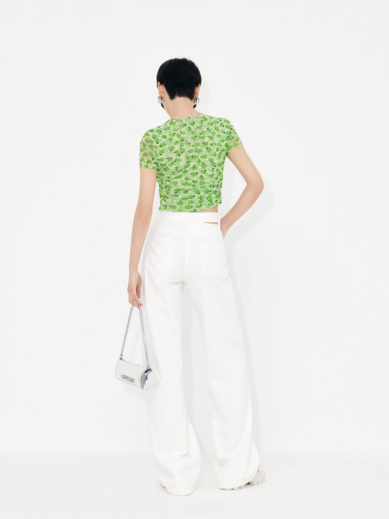 Stay stylish and comfortable with MO&Co.'s Floral Print Pleated Crop Top in Green. Crafted with lightweight mesh fabric and pleated side details, this top will flatter your shape while the fresh floral print adds an elegant touch.