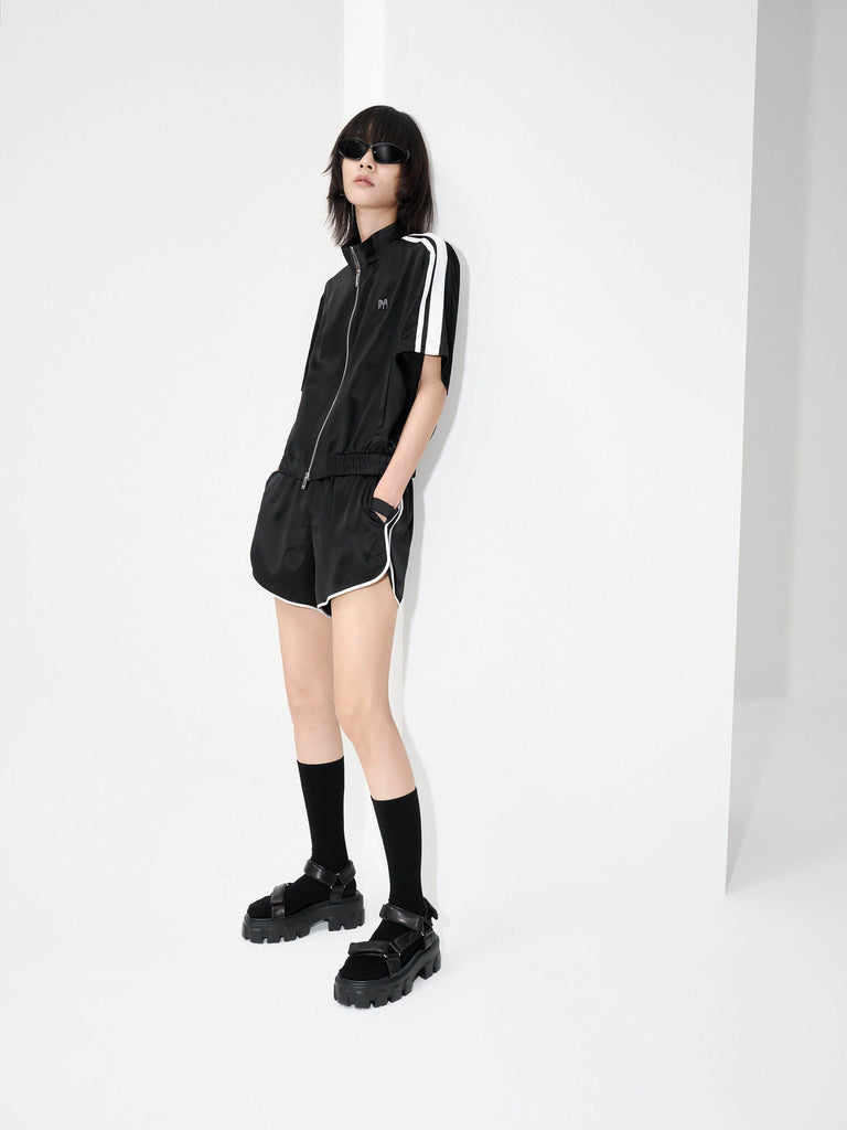 MO&Co. Women's Satin Acetate Blend Casual Track Jacket in Short Sleeves in Black. Features: Loose fit, contrasting trim design, elasticized hem, side pockets & zip closure, and an acetate blend fabric for softness & comfort.