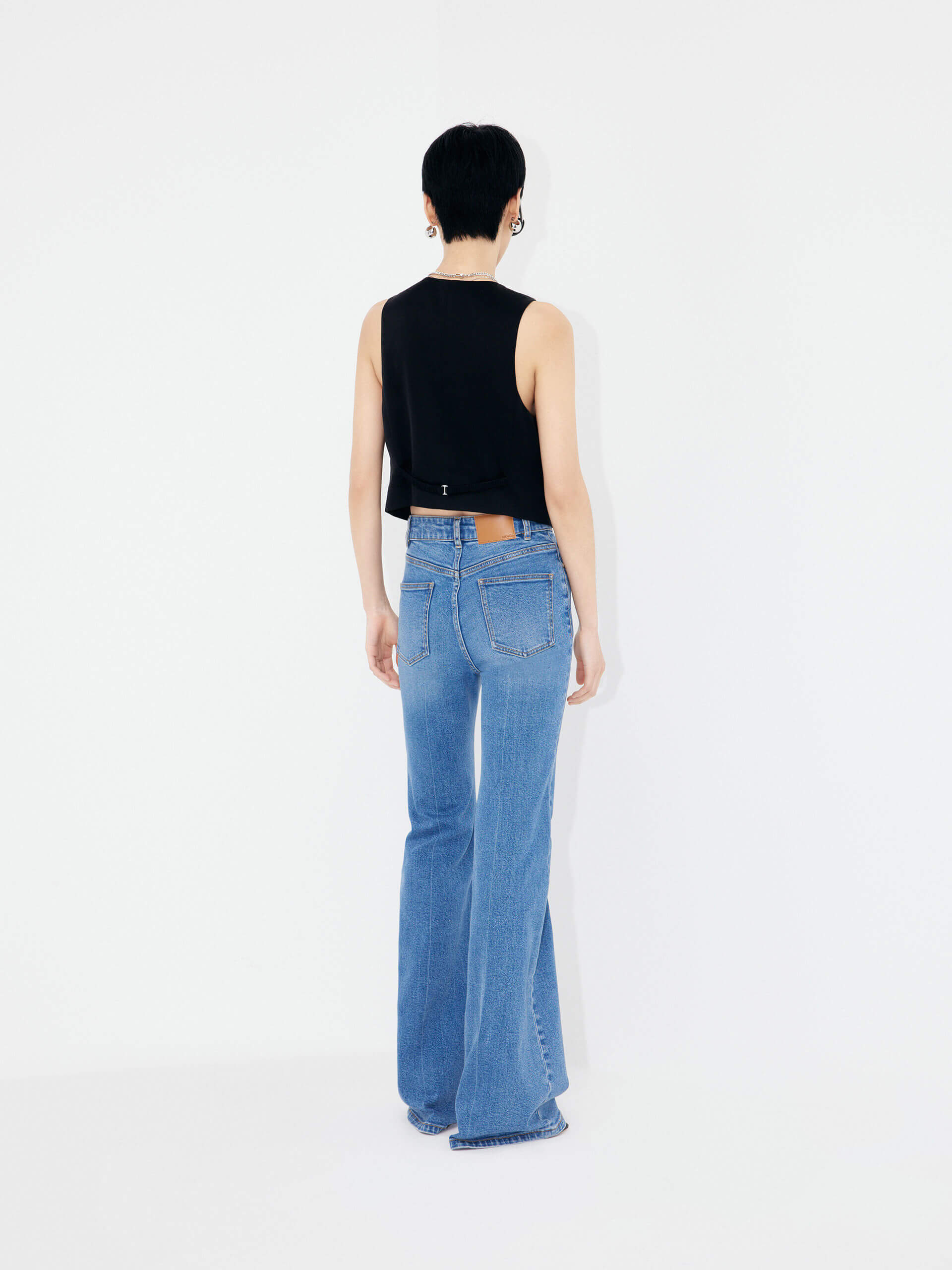 Experience MO&Co.'s Women's Full Length Flared Jeans - featuring flared legs, button and zip closure, five-pocket design, whiskered effect and belt loops alongside a leather logo patch at back waistband.