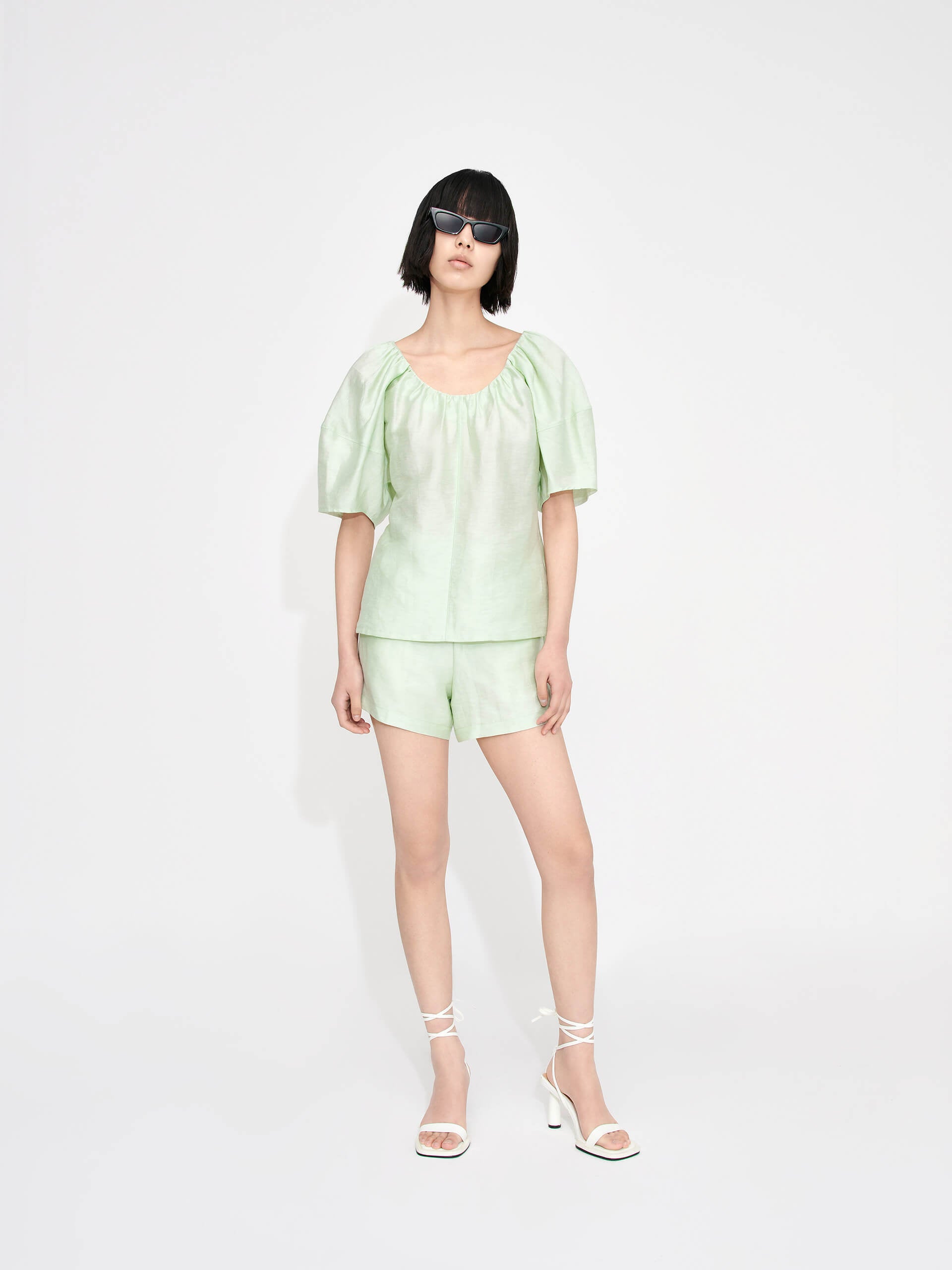 Stay cool and stylish in the MO&Co. Women's Linen Blend Relaxed Top in Mint. This lightweight top features a gathered neckline, soft glossy linen blend material, and a loose fit for ultimate comfort in the summer heat. The perfect choice for effortless summer style.