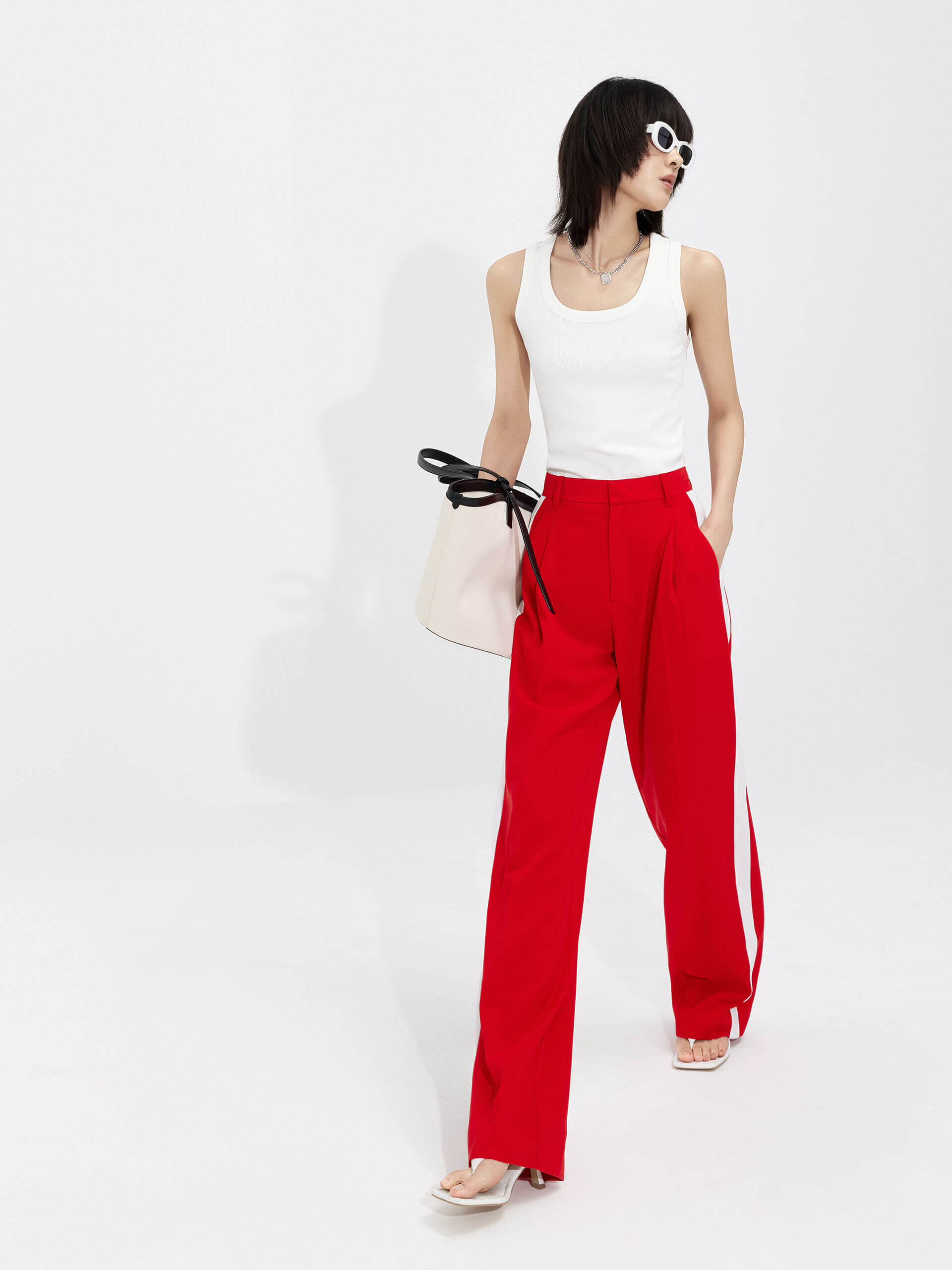 MO&Co. Women's Contrast Trim Suit Pants in Red offer timeless style and lasting comfort. Features include contrast trim design, straight leg, side pockets, belt loops, and a zipper and hook closure.