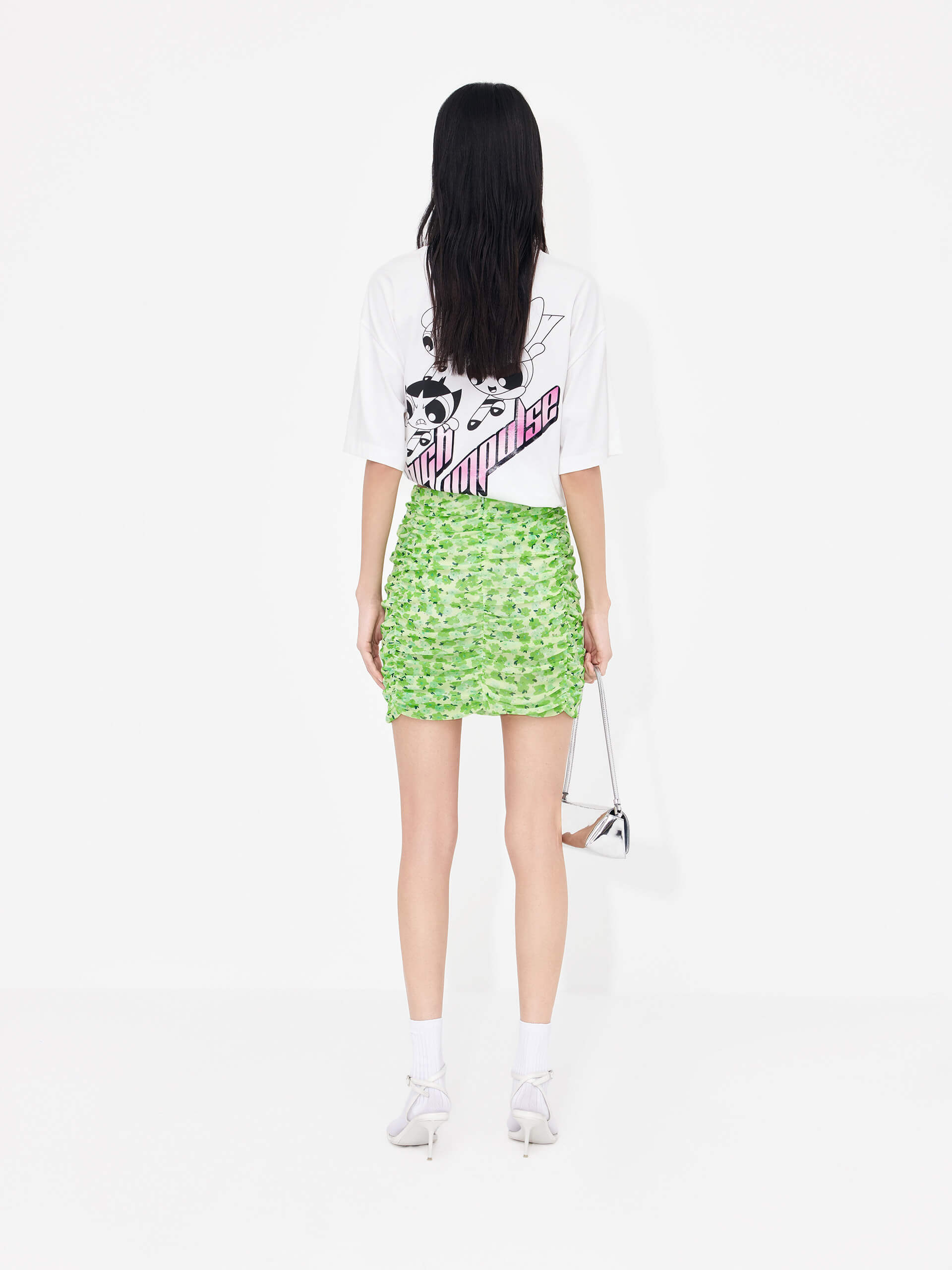 The MO&Co Women's Pleated Floral Print Mini Skirt in Green is a stylish wardrobe staple perfect for a polished look. Crafted from lightweight mesh with a pleated design, it features a classic flower print and draped detailing. A hidden side zipper and inner lining provide a comfortable, secure fit.