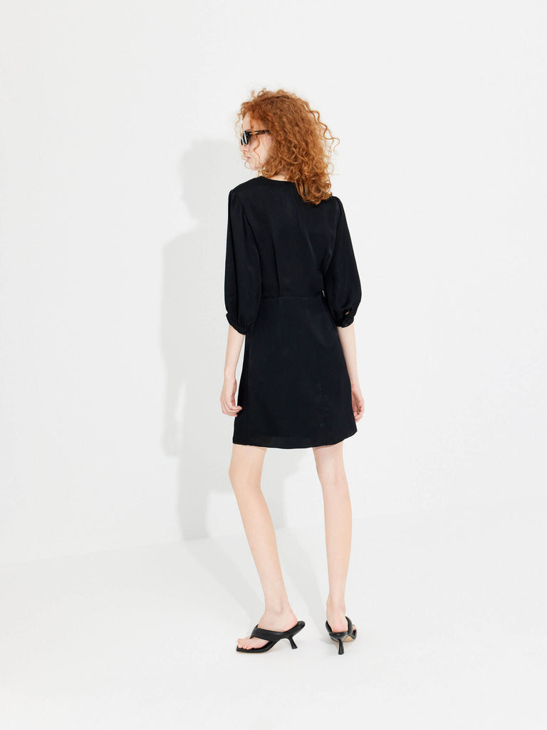 MO&Co. Women's Twisted Front V-neck Mini Dress in Black crafted with eco-friendly regenerated fibers.