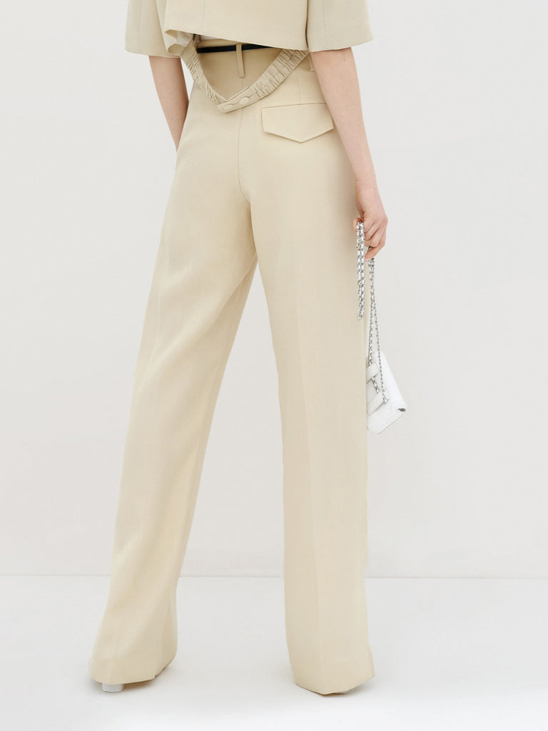MO&Co. Women's Pleated Suit Pants with Belt in Camel features high-rise, slit detail at hems, straight leg fit.